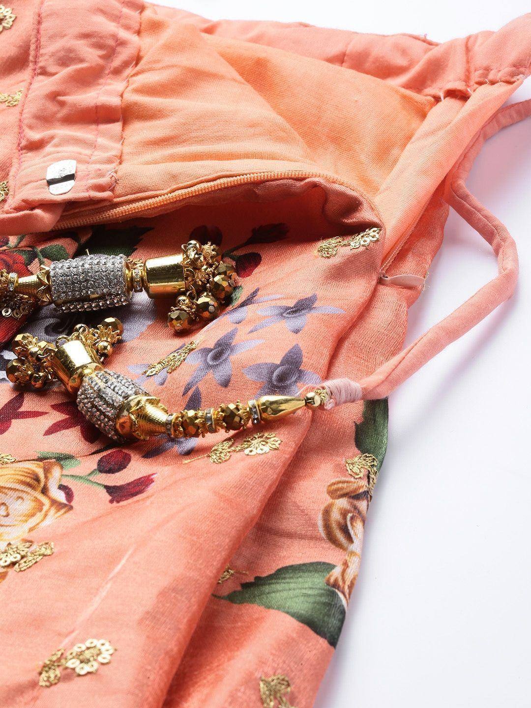 Peach floral lehenga choli with gold embroidery and embellished tassels, perfect for ethnic occasions