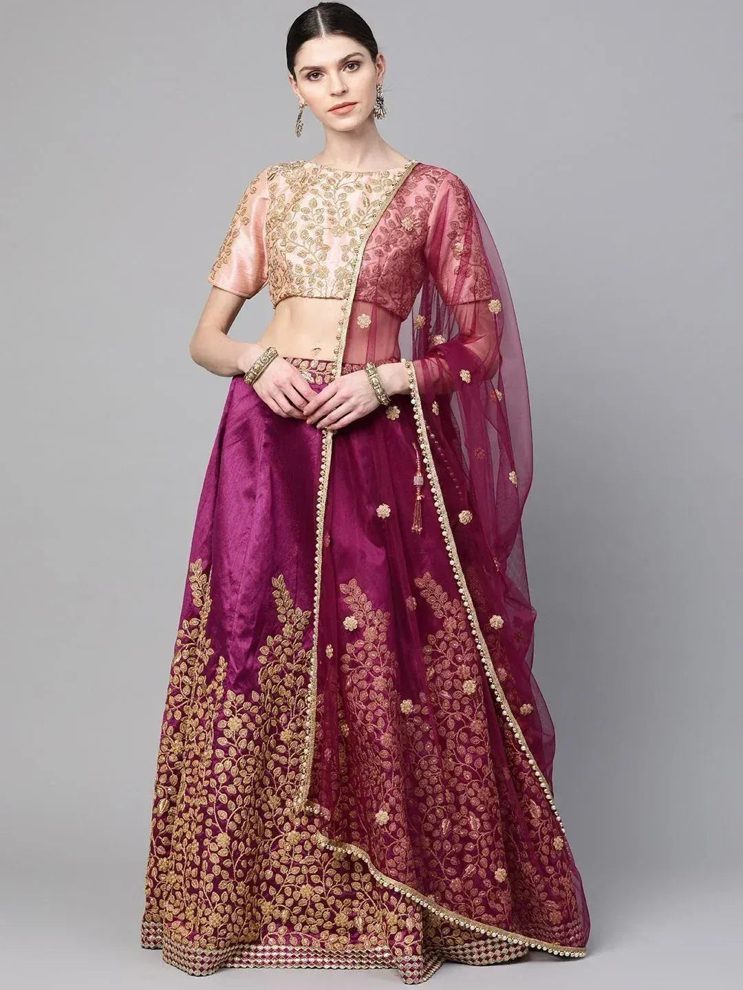 Elegant maroon lehenga choli with gold embroidery, perfect for Indian weddings and festive occasions