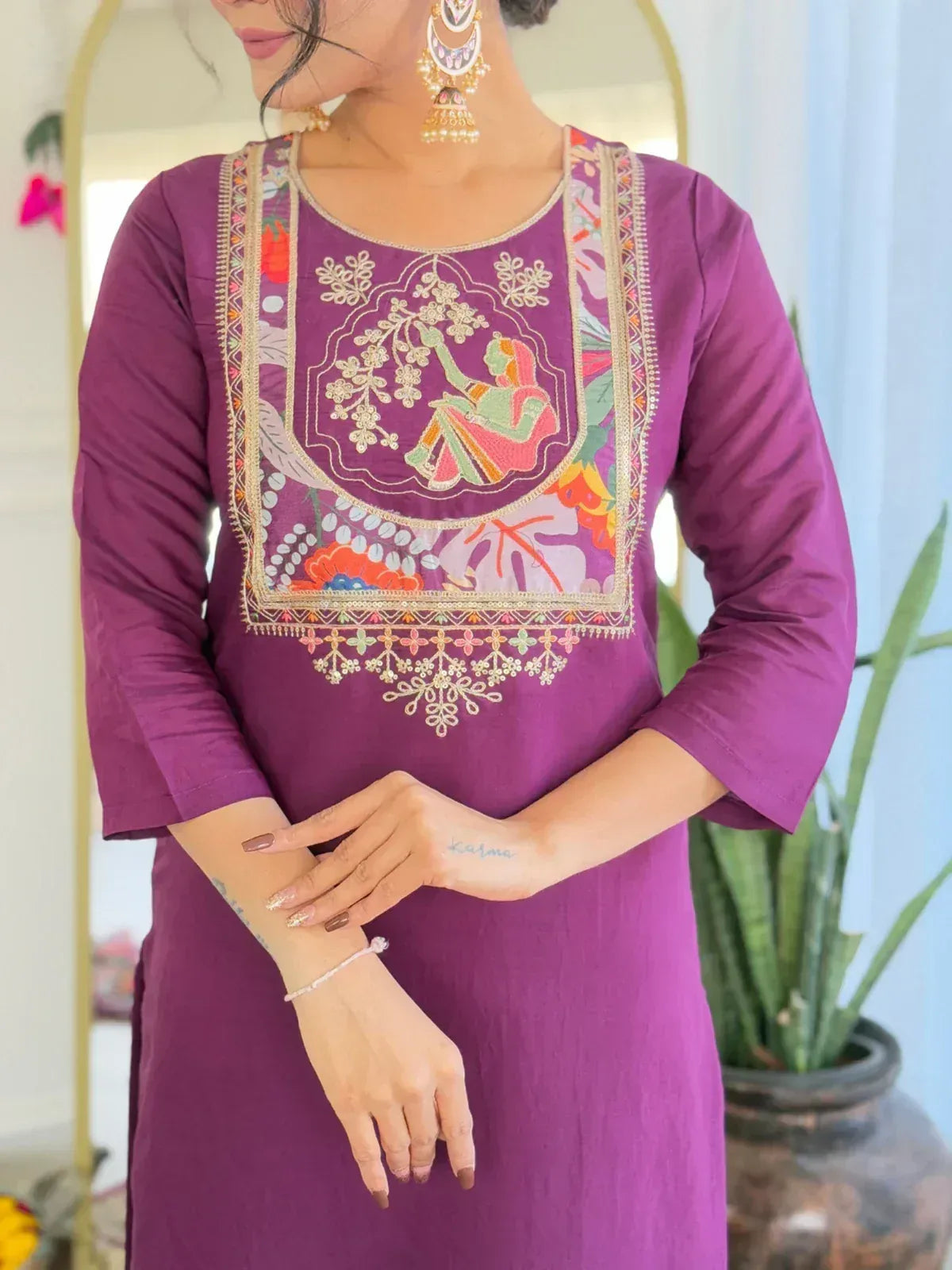 Purple embroidered ethnic kurti with floral and figurative design, perfect for Indian wear.