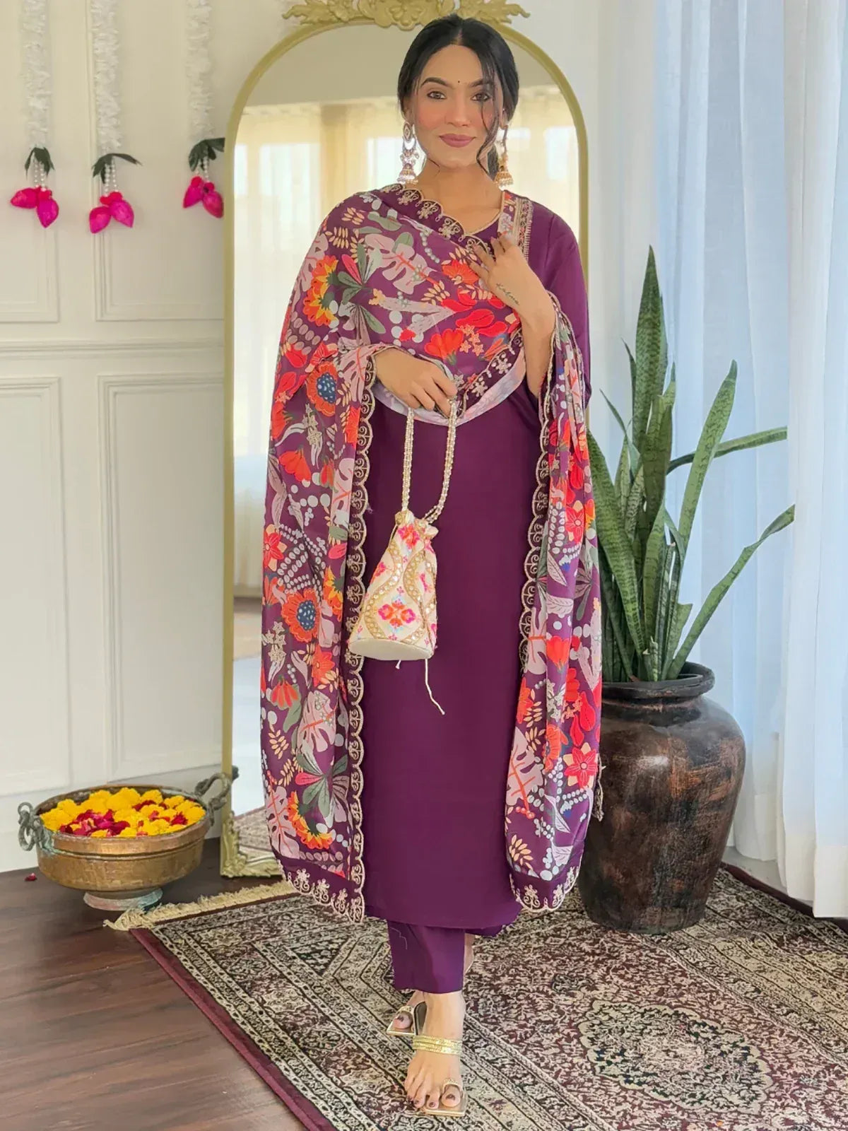 Purple floral printed ethnic salwar kameez with matching dupatta and potli bag