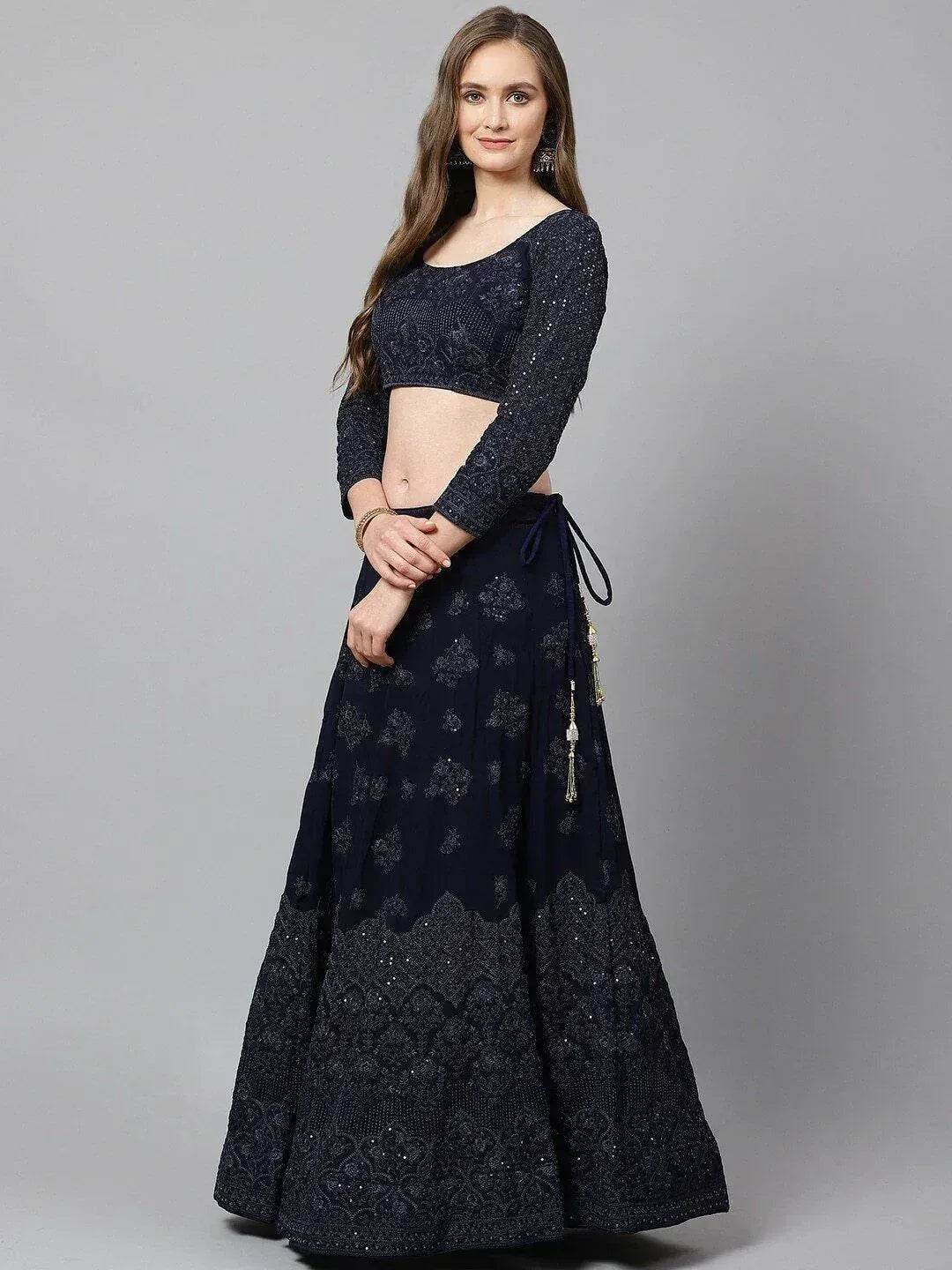 Navy blue embroidered lehenga choli with long sleeves and tassel details, perfect for Indian ethnic wear occasions.