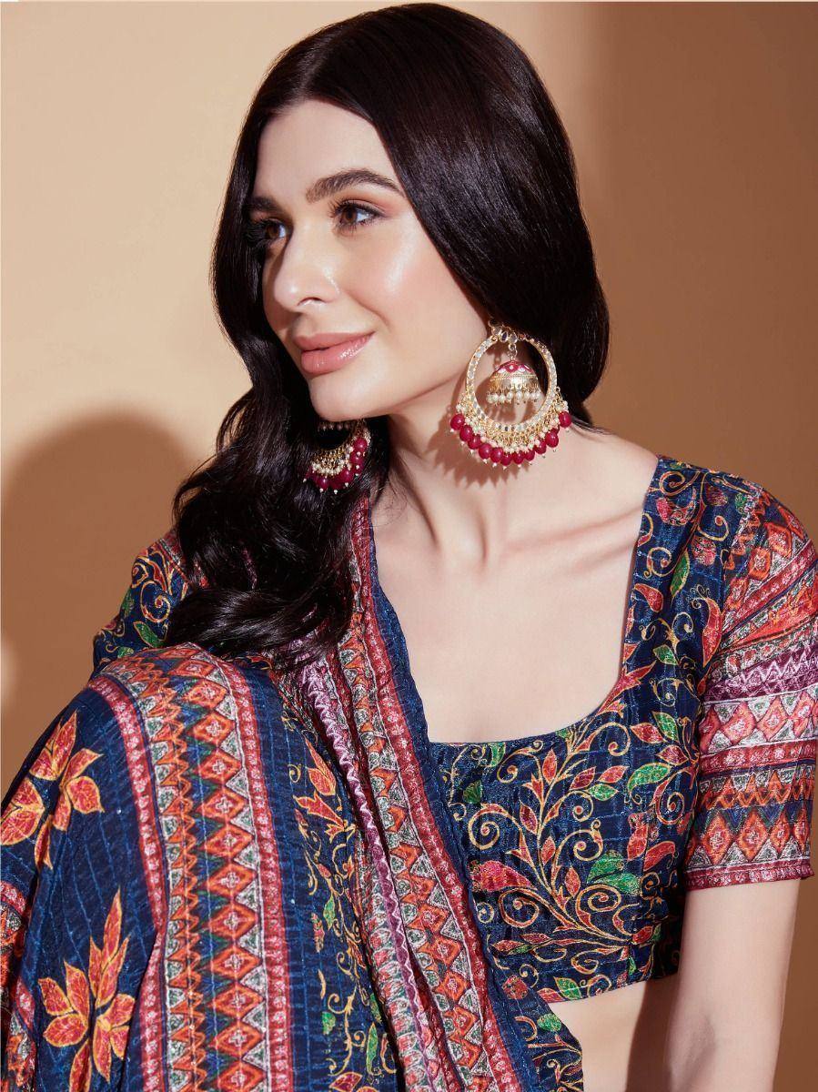 Woman in vibrant printed ethnic blouse with floral patterns and traditional jhumka earrings