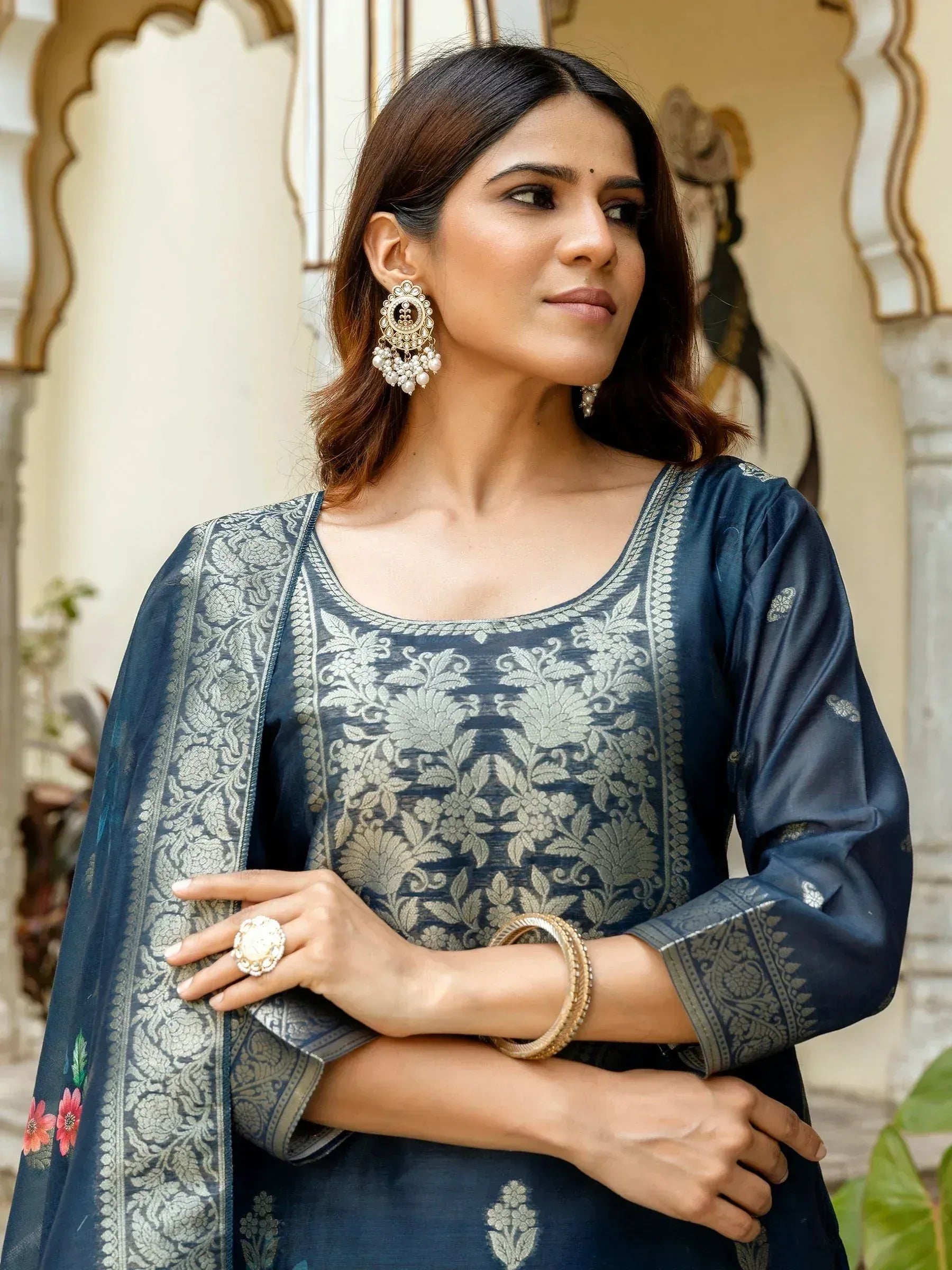 Woman in elegant navy blue ethnic salwar kameez with silver floral embroidery and traditional jewelry