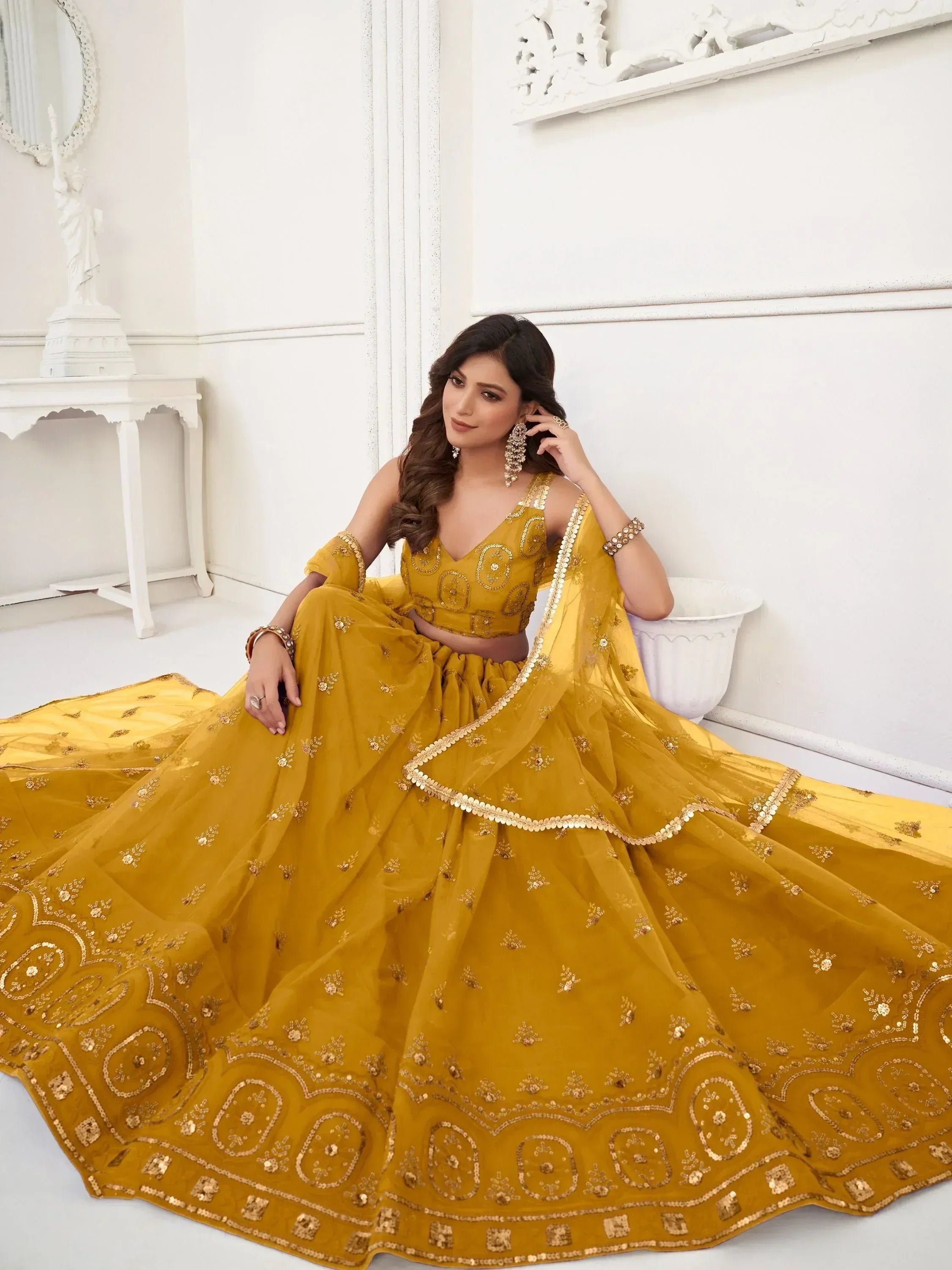 Mustard yellow designer lehenga choli with gold embroidery, perfect for Indian weddings and festive occasions.