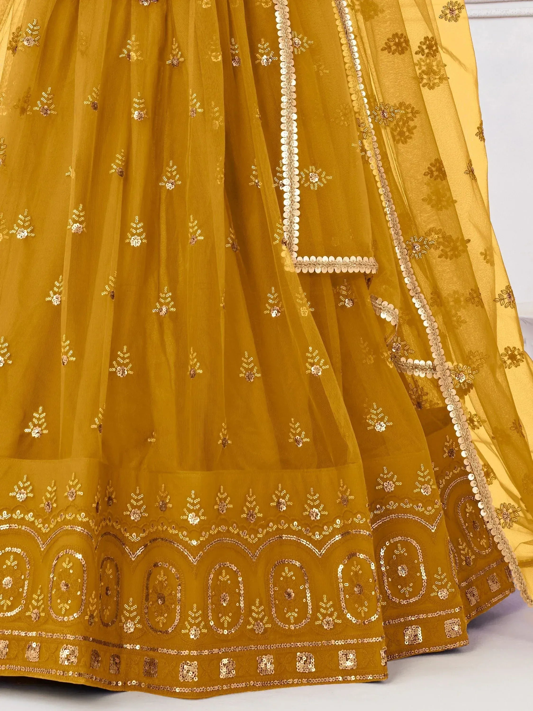 Mustard yellow lehenga choli with floral sequin embroidery and scalloped border detailing