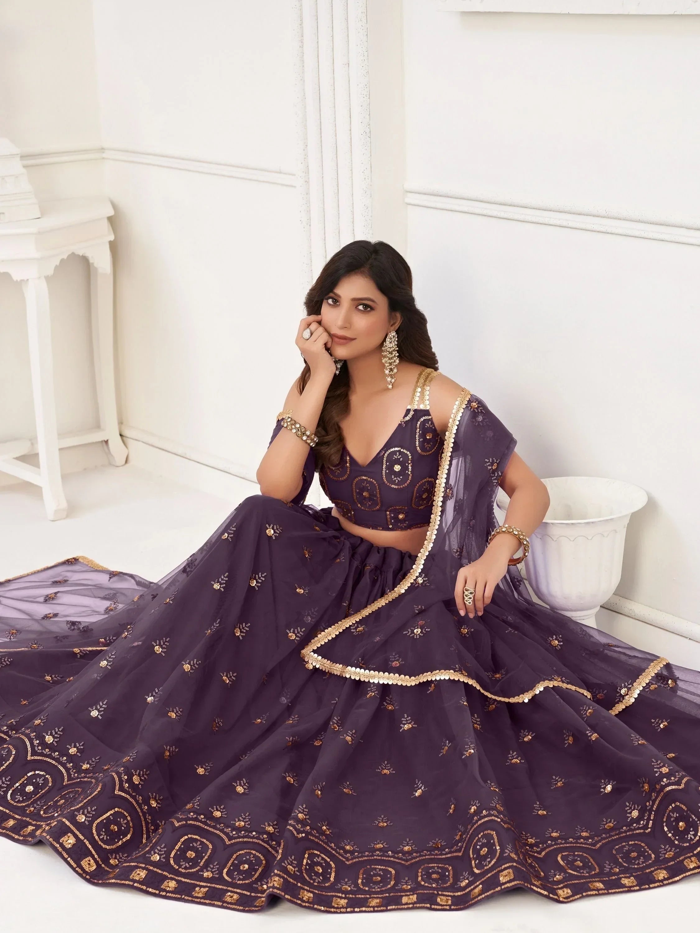 Purple embroidered lehenga choli with gold detailing, perfect for Indian ethnic wear and festive occasions.