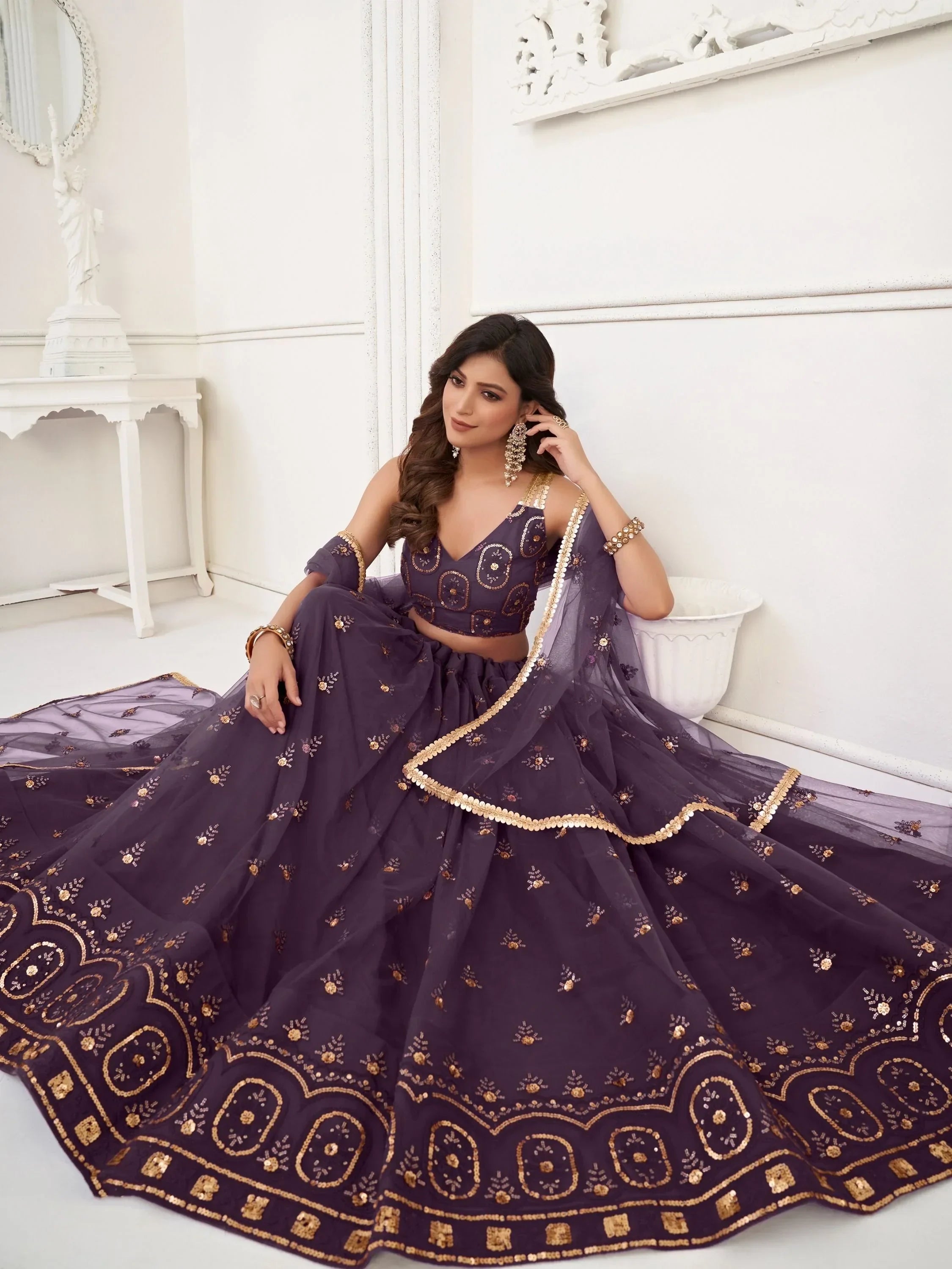Elegant purple lehenga choli with gold embroidery, perfect for Indian weddings and festive occasions.