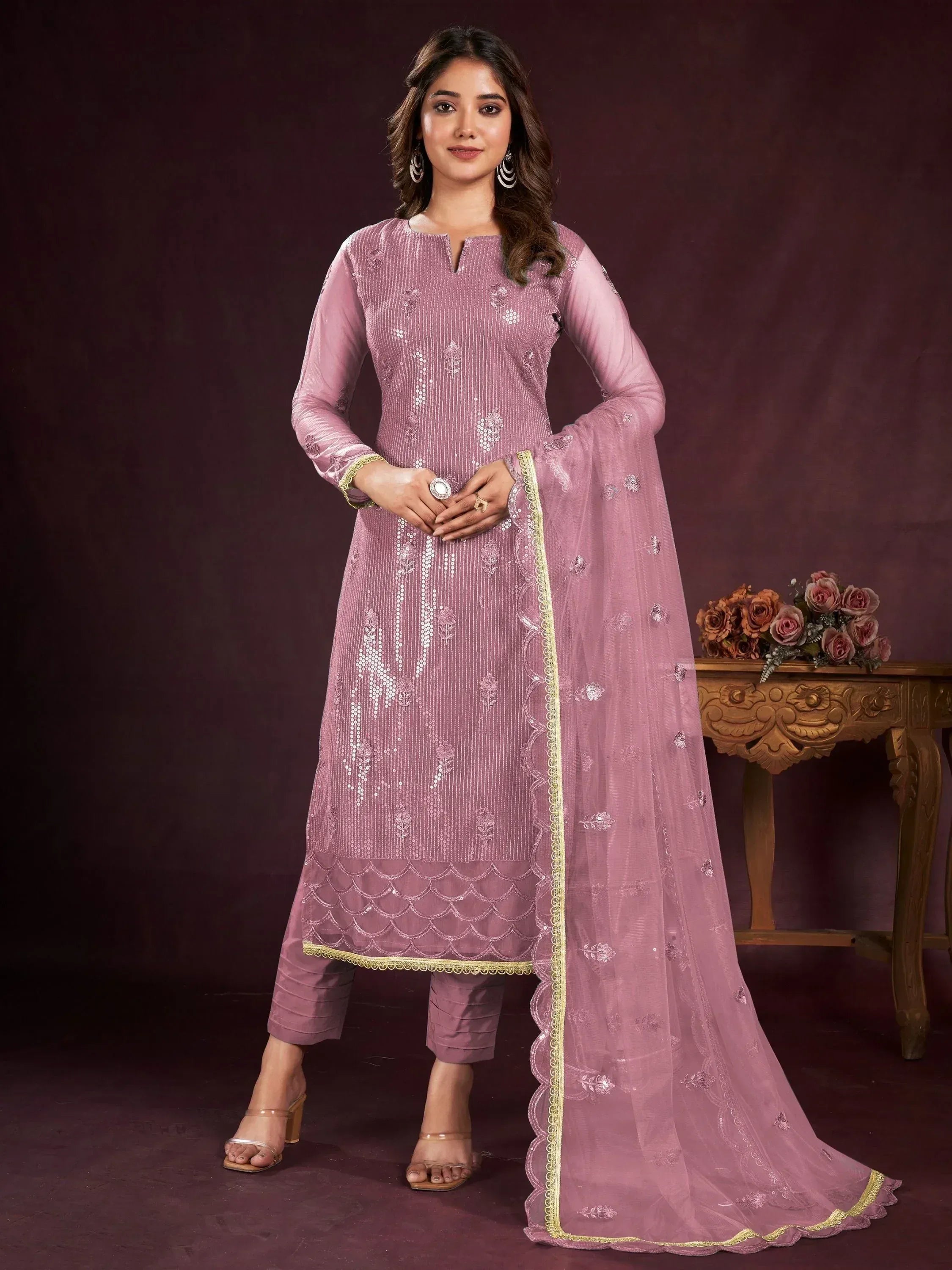 Elegant pink embroidered salwar kameez with scalloped detailing and gold trim, perfect for ethnic occasions.