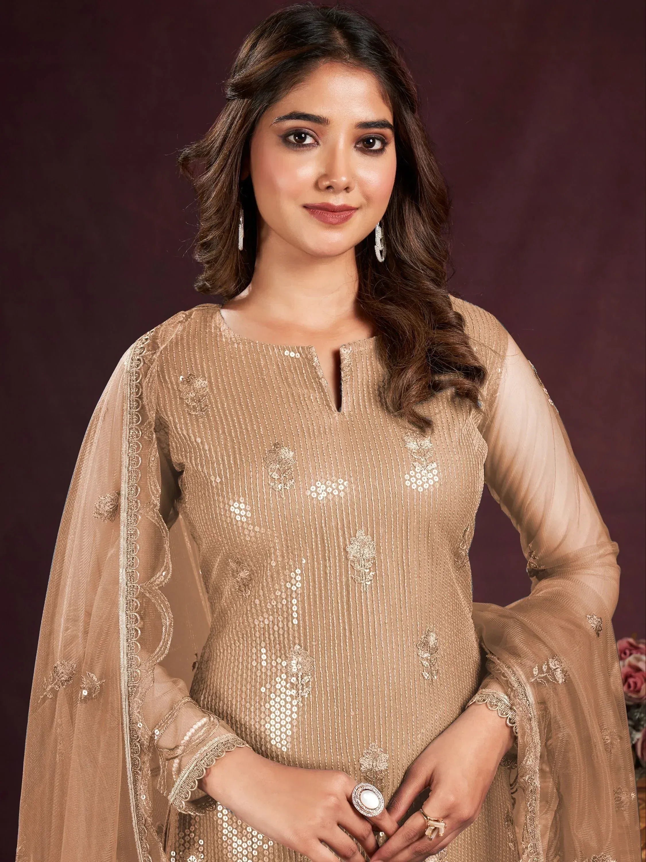 Elegant beige sequin embroidered ethnic wear with sheer sleeves and floral detailing for festive occasions