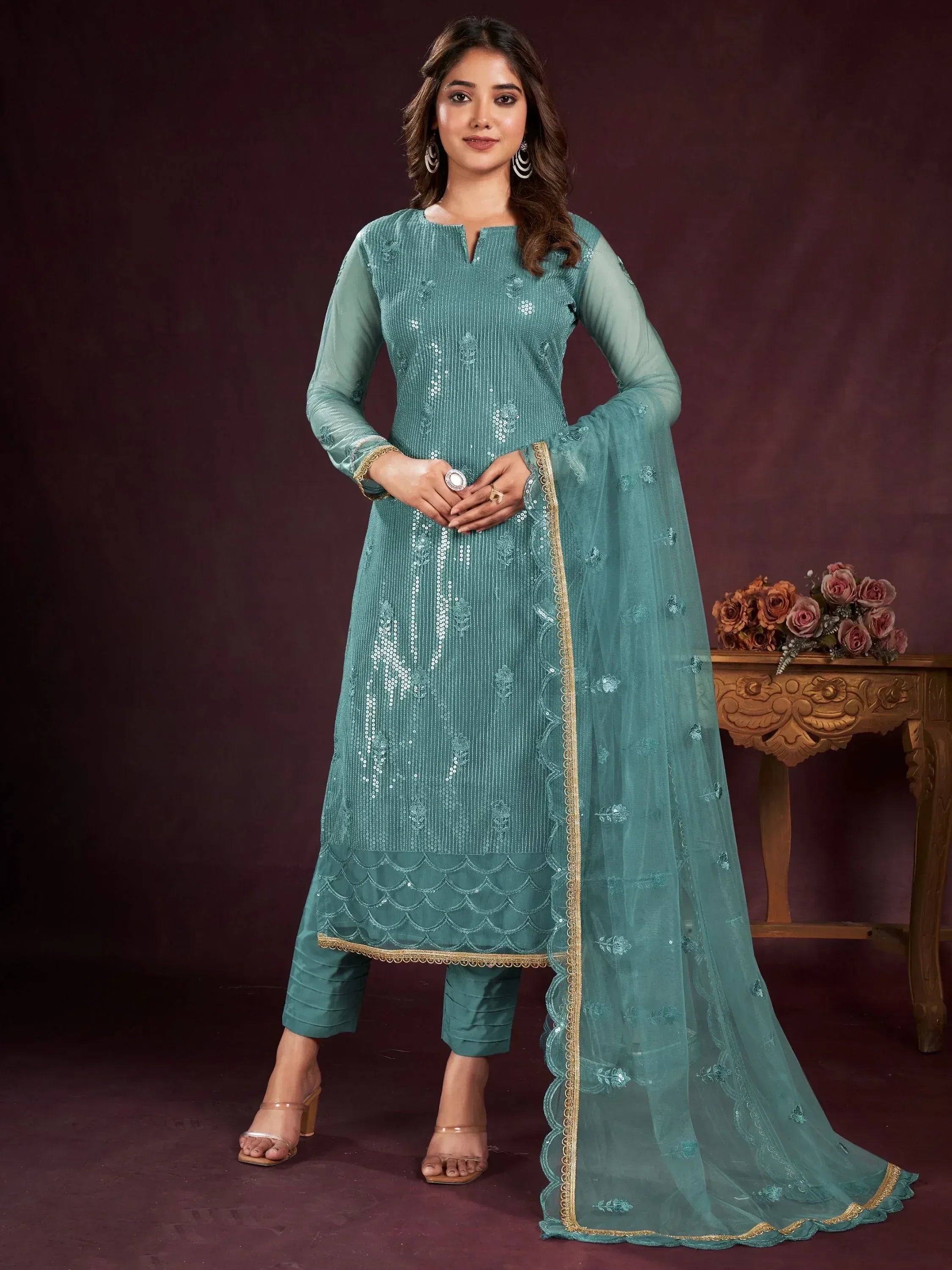 Teal embroidered salwar kameez with gold trim and sheer dupatta, perfect for ethnic occasions