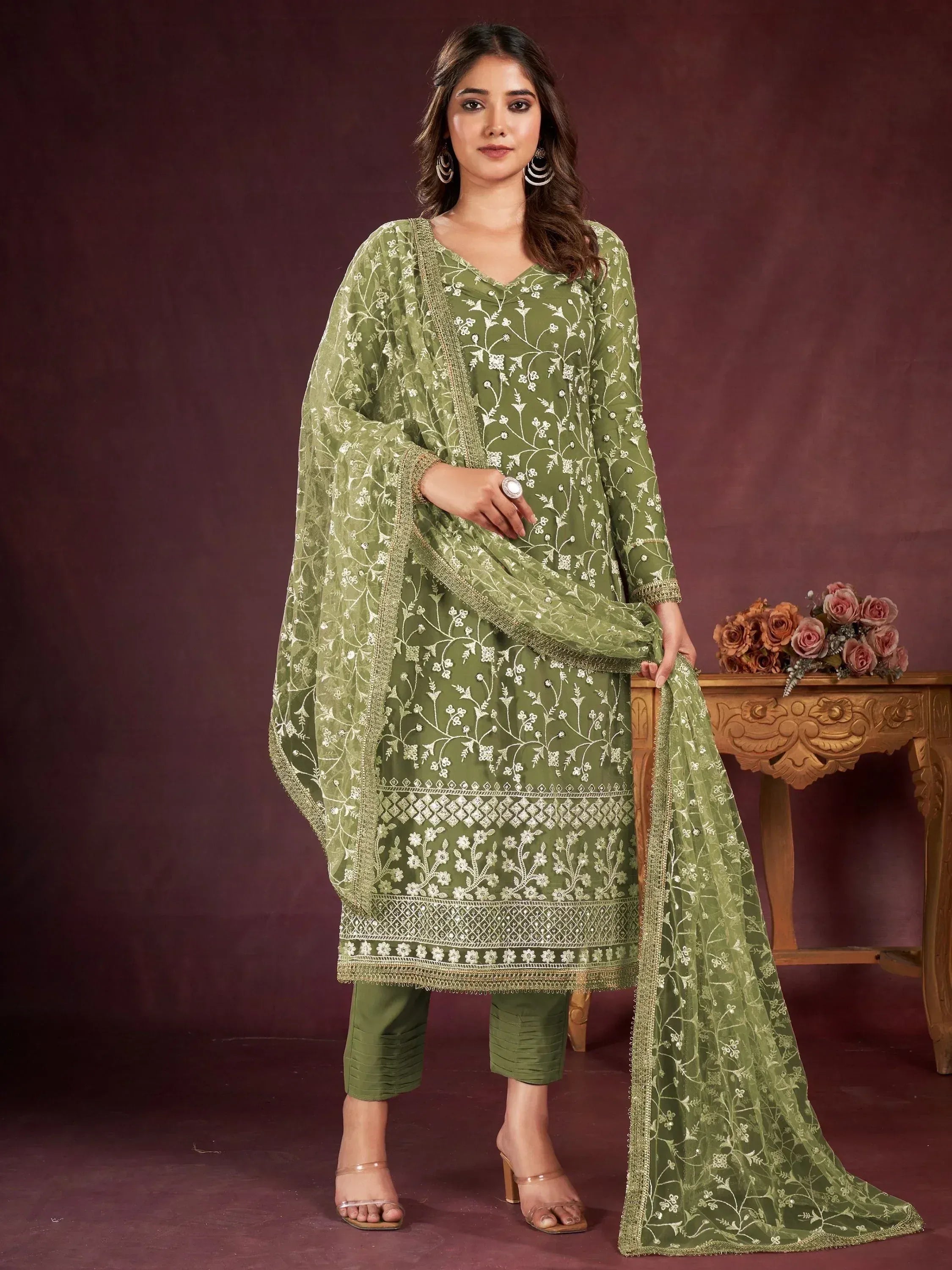 Olive green embroidered salwar kameez with floral work, matching dupatta, and palazzo pants for women.