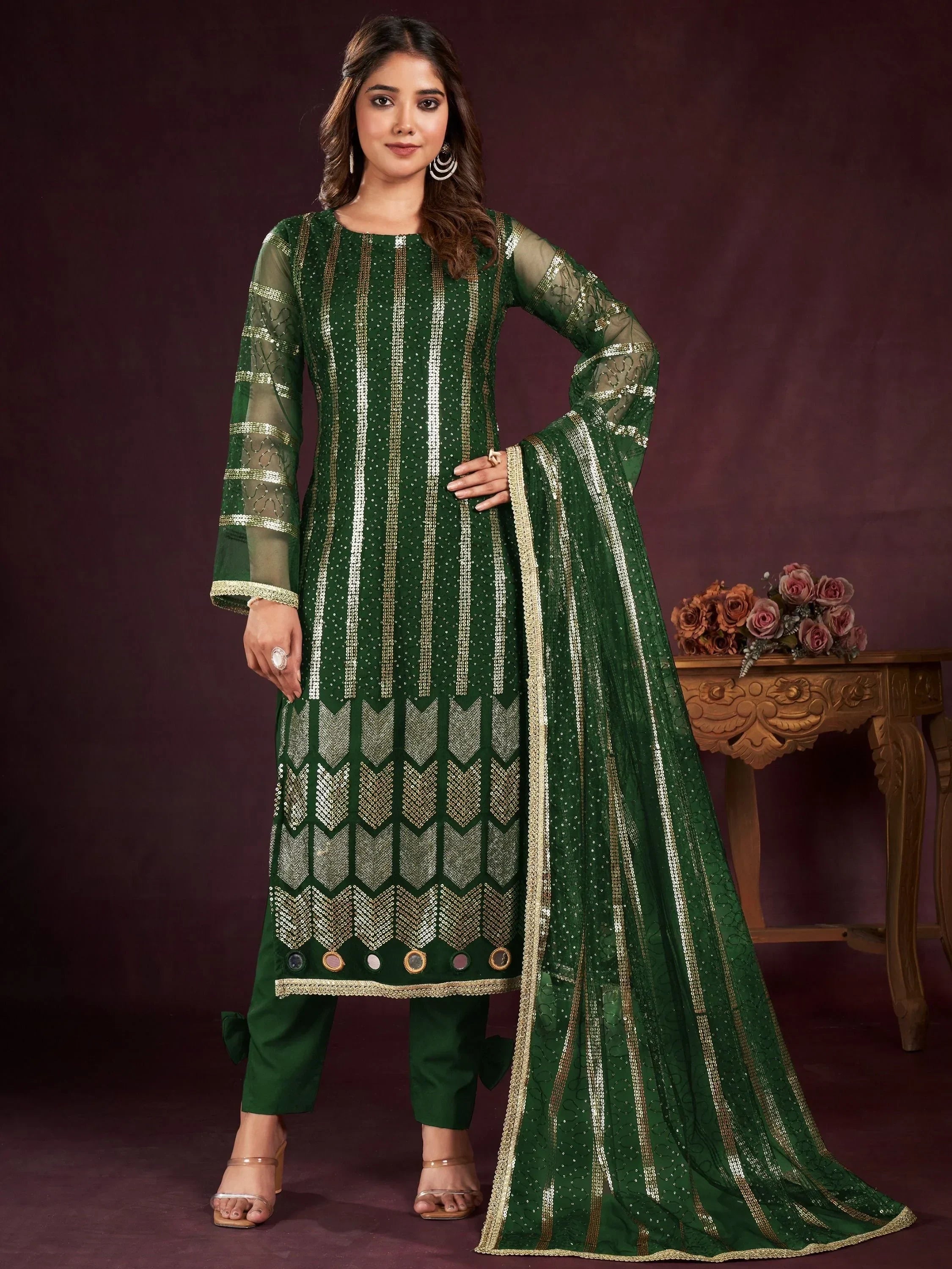 Woman wearing green embroidered salwar kameez with dupatta, ethnic Indian outfit
