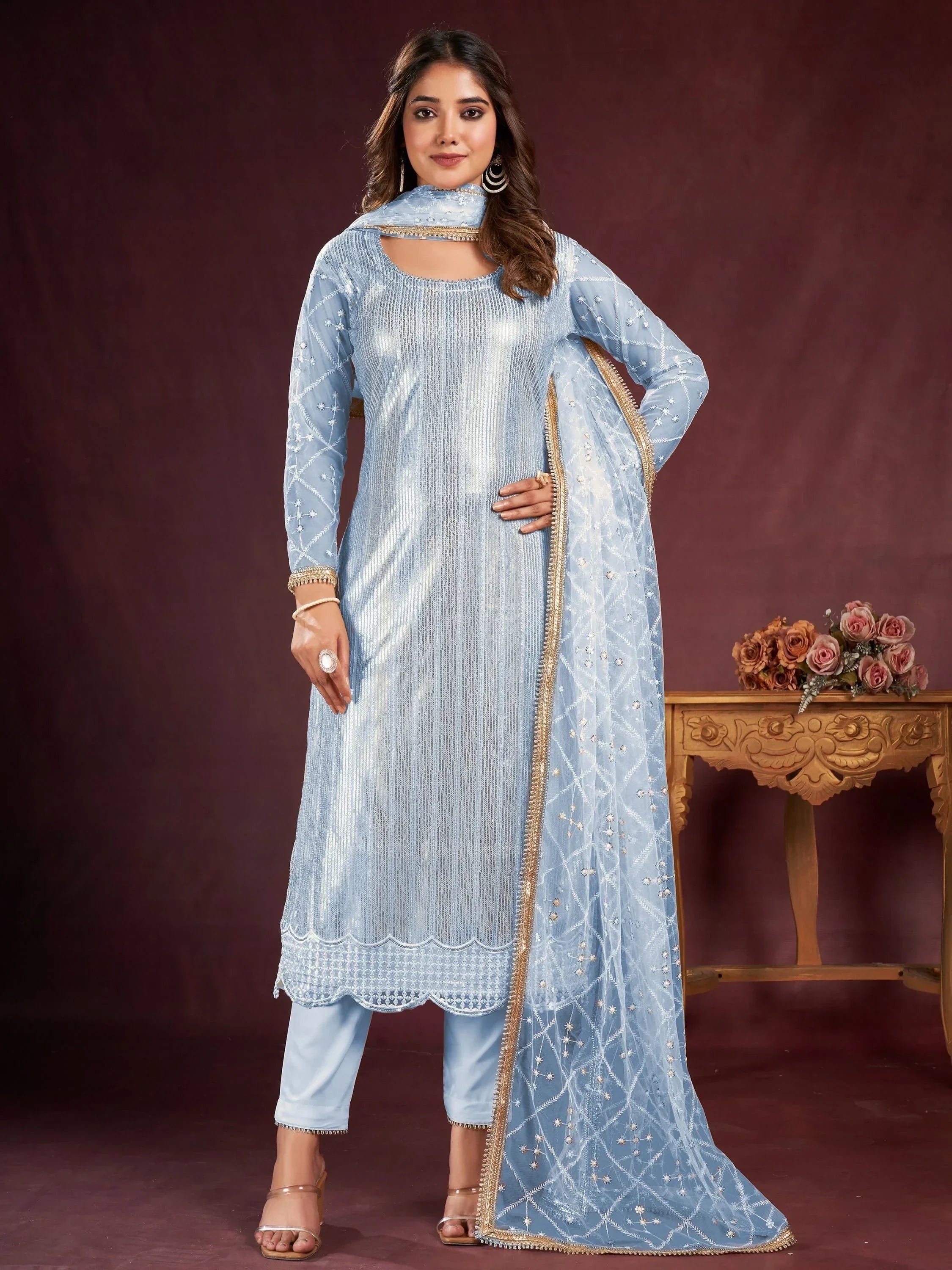 Woman in light blue embroidered salwar kameez with sheer dupatta, festive ethnic wear