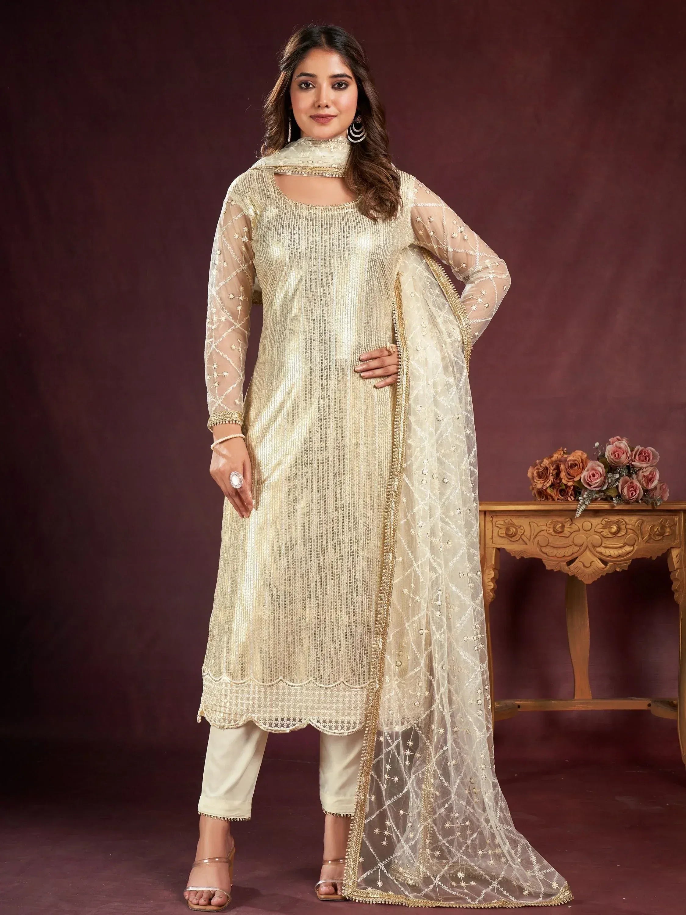 Elegant gold embroidered salwar kameez with sheer dupatta, perfect for festive occasions