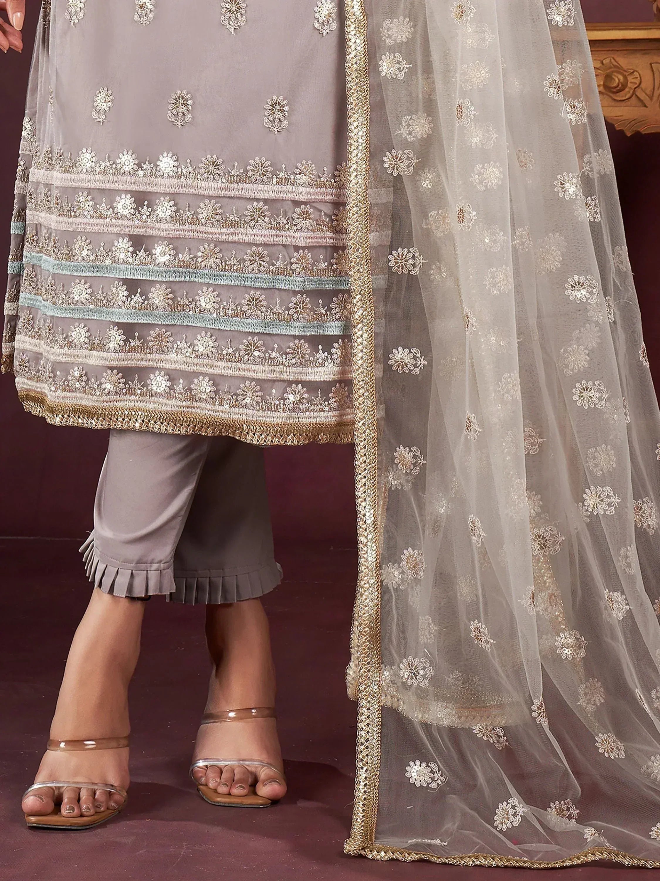 Grey embroidered salwar kameez with floral motifs, sheer dupatta, and pleated pants for ethnic wear