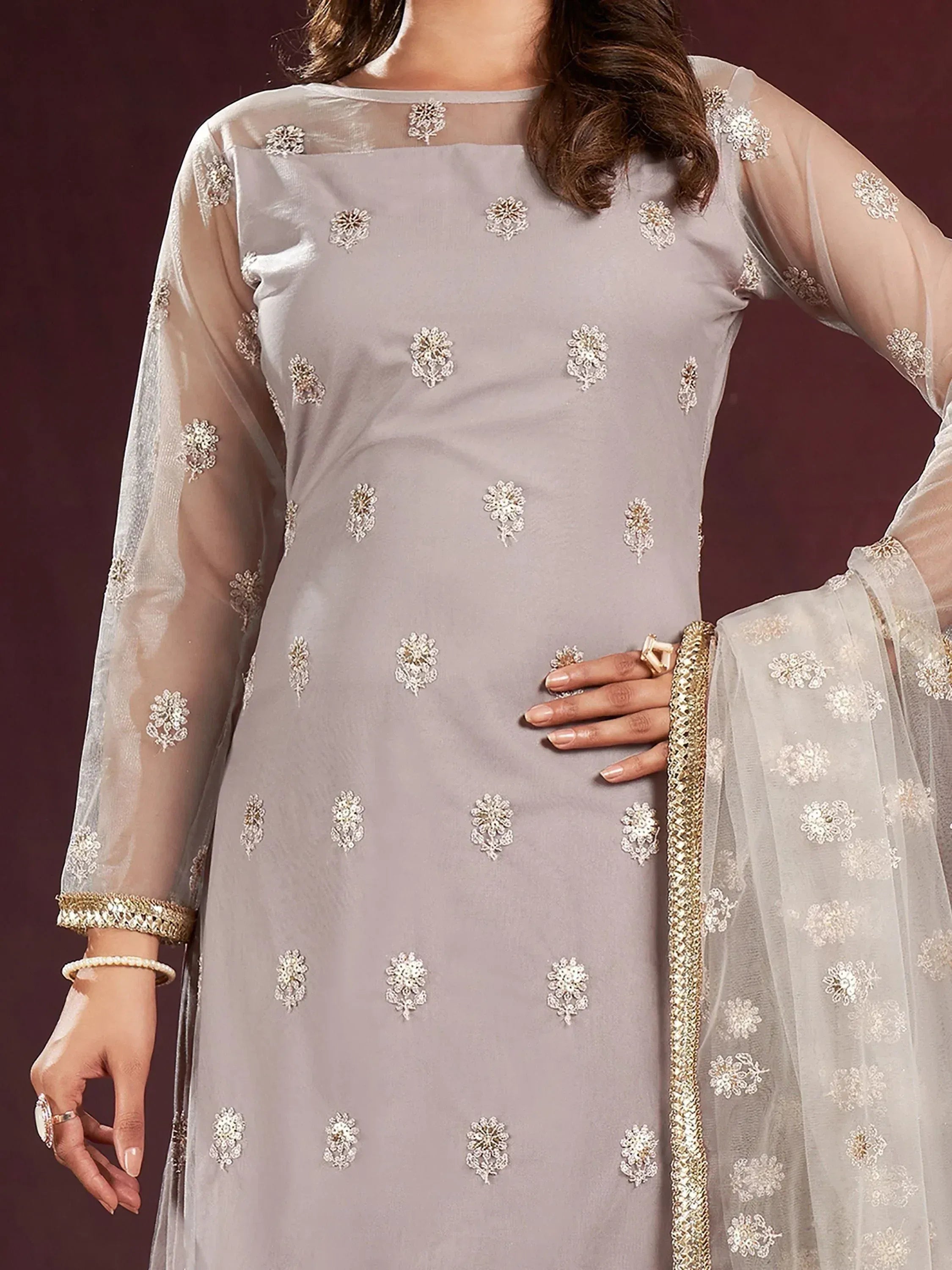 Elegant grey embroidered salwar kameez with sheer sleeves and gold detailing, perfect for ethnic occasions.