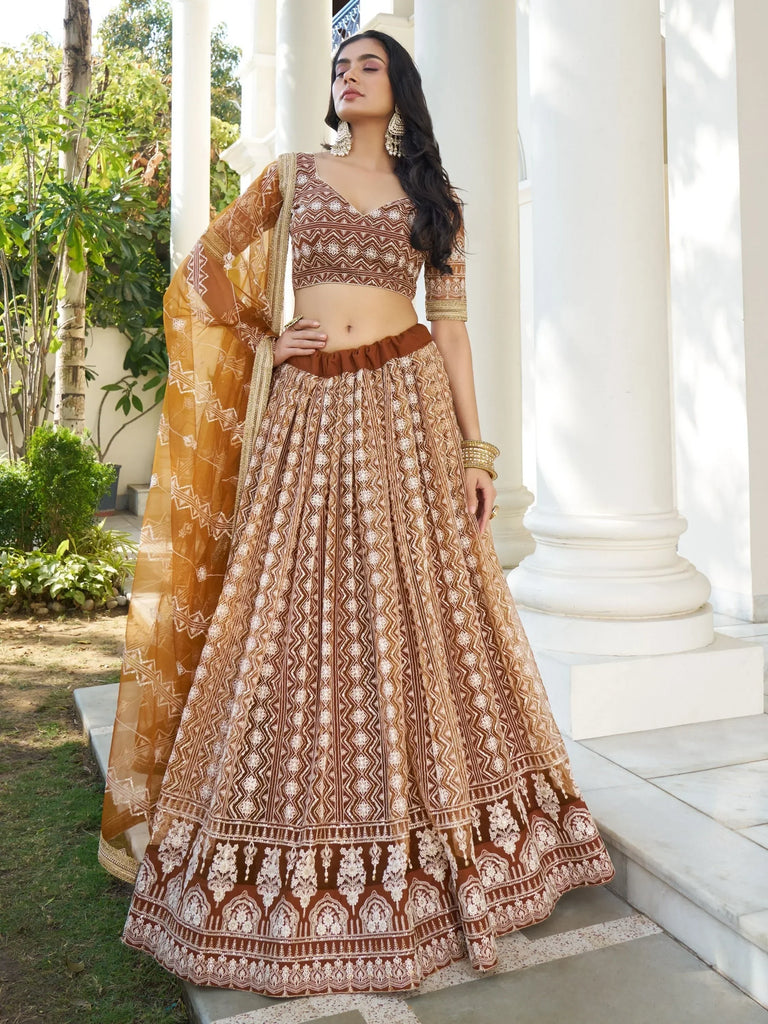 Brown and gold embroidered lehenga choli with geometric print, perfect for Indian ethnic wear occasions.