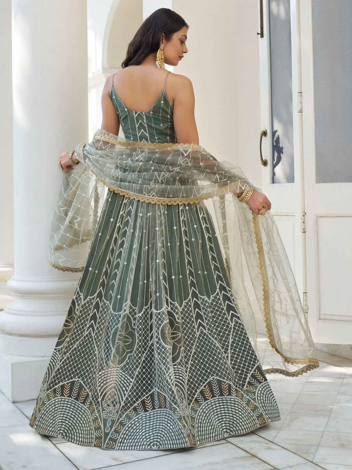 Olive green designer lehenga choli with gold embroidery, sheer dupatta, perfect for Indian weddings or festive occasions.