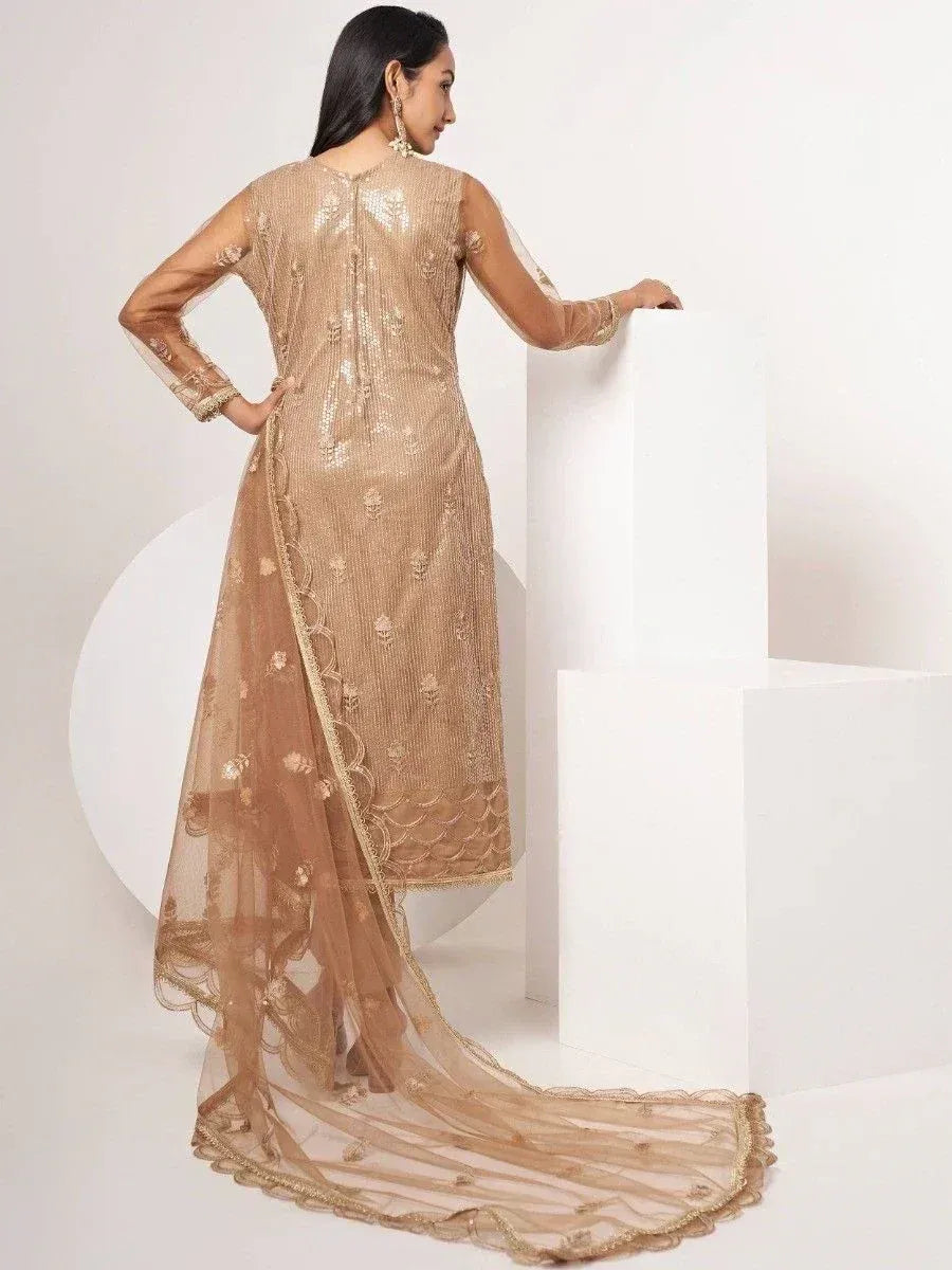 Elegant gold embroidered ethnic gown with sheer dupatta, perfect for Indian festive occasions.