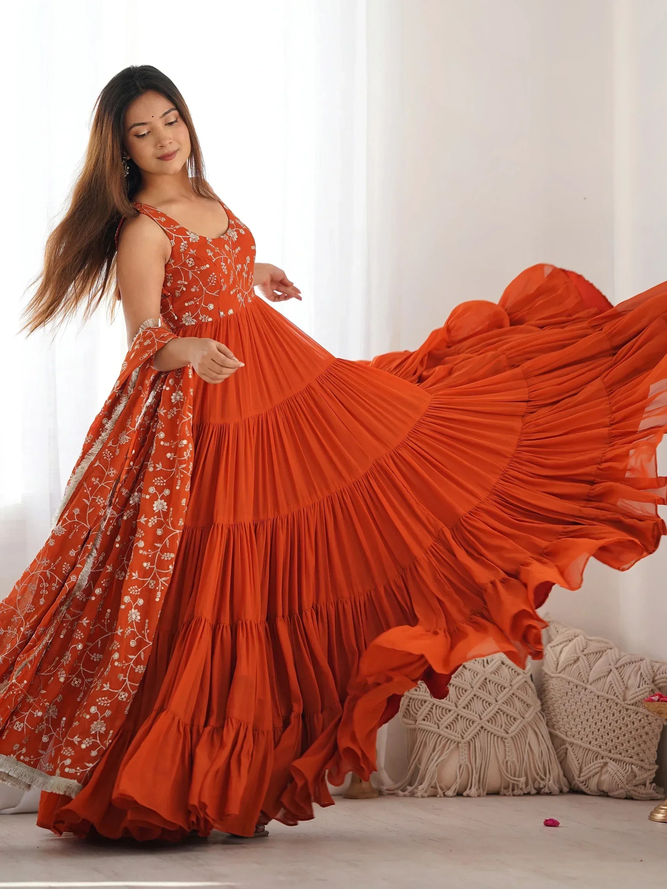Orange ethnic gown with floral embroidery and tiered pleated skirt for women