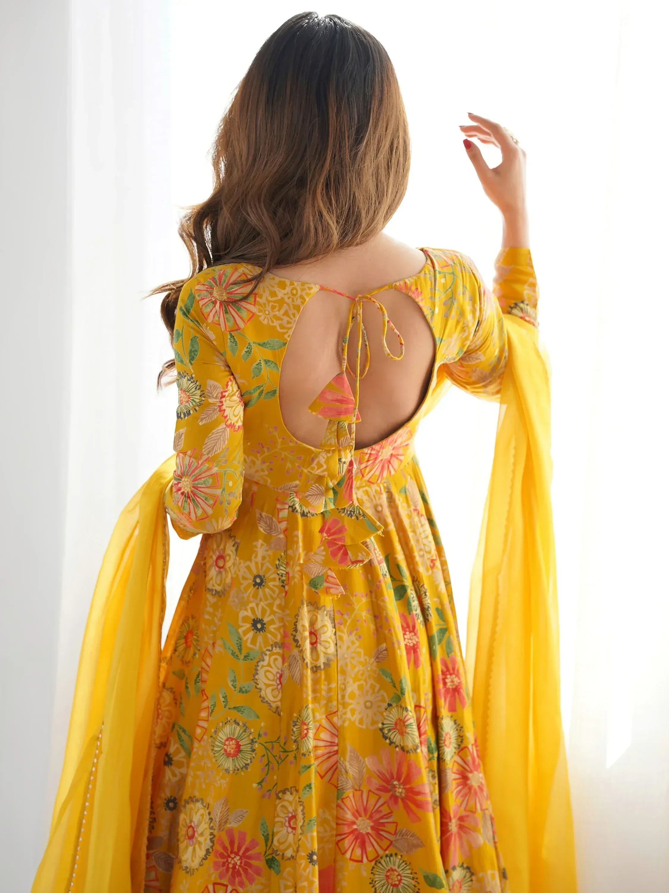 Yellow floral ethnic gown with back tie detail, perfect for Indian occasions and festive wear.