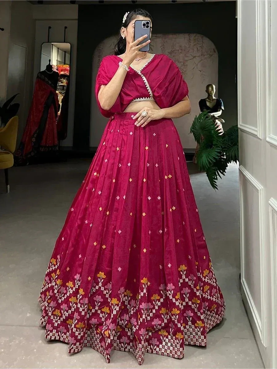 Woman in maroon lehenga choli with floral embroidery, perfect for Indian ethnic wear occasions