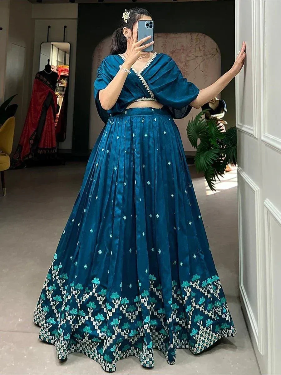 Teal blue lehenga choli with floral border, perfect for Indian ethnic occasions and weddings