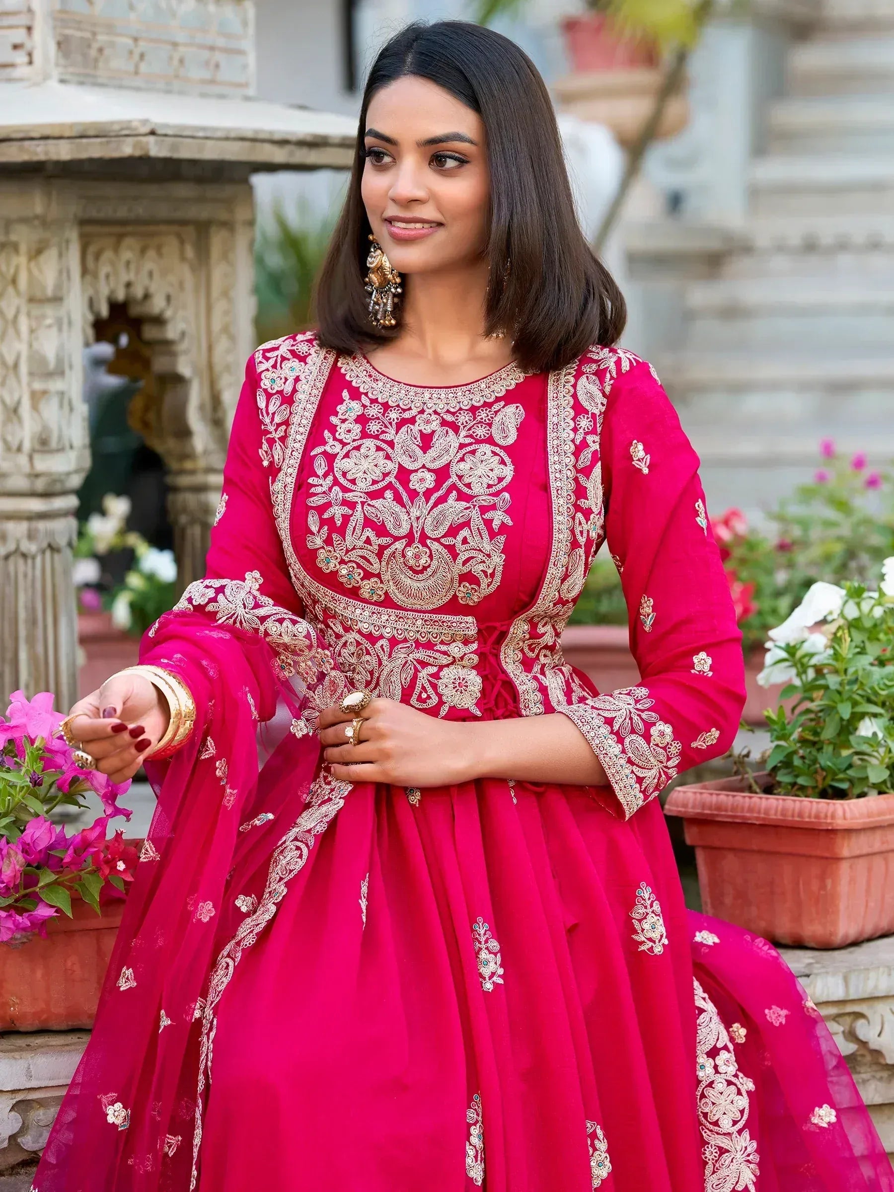 Elegant pink embroidered ethnic gown with floral detailing, perfect for Indian celebrations.