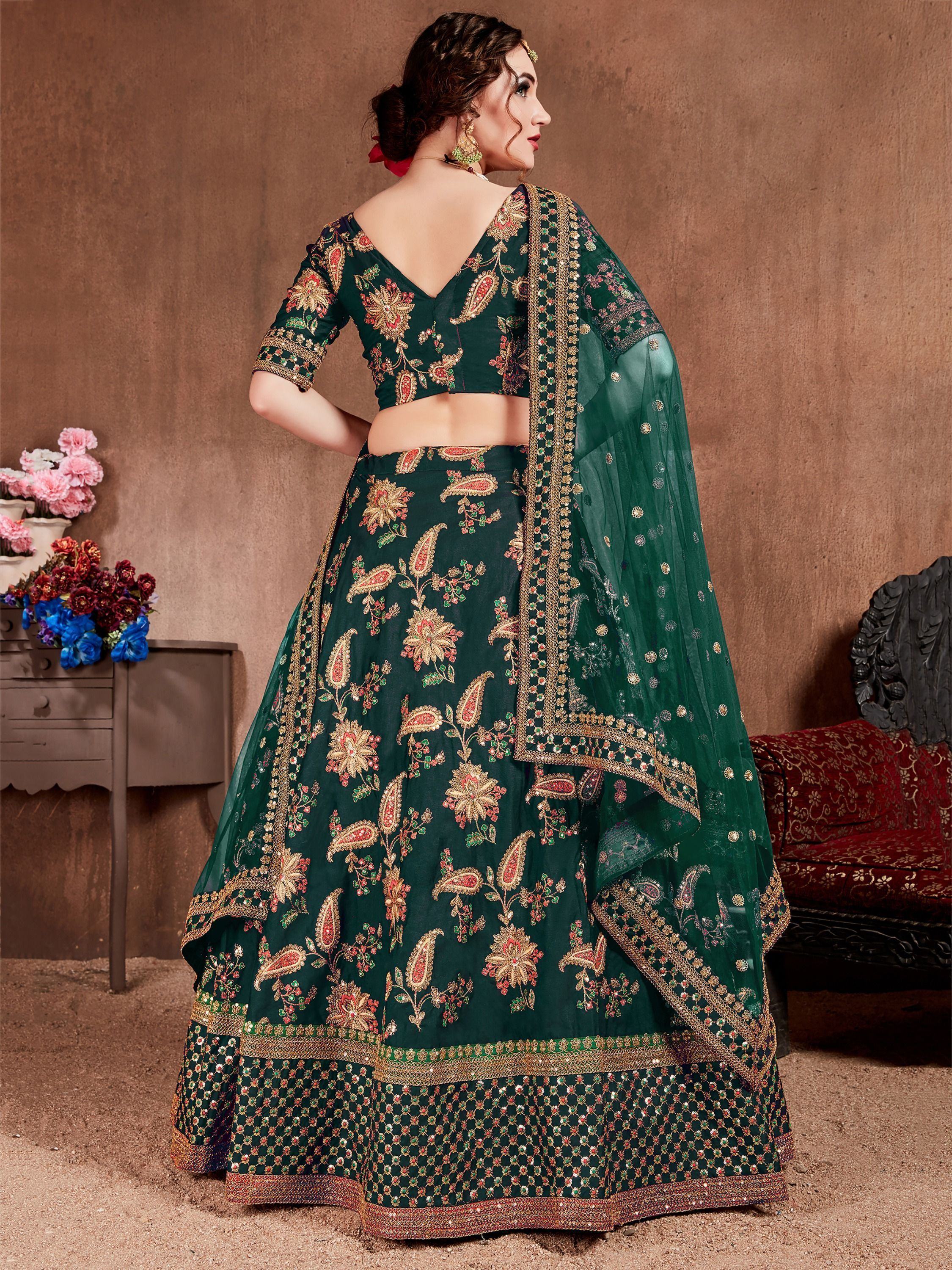 Emerald green designer lehenga choli with floral embroidery and gold detailing, perfect for Indian weddings.