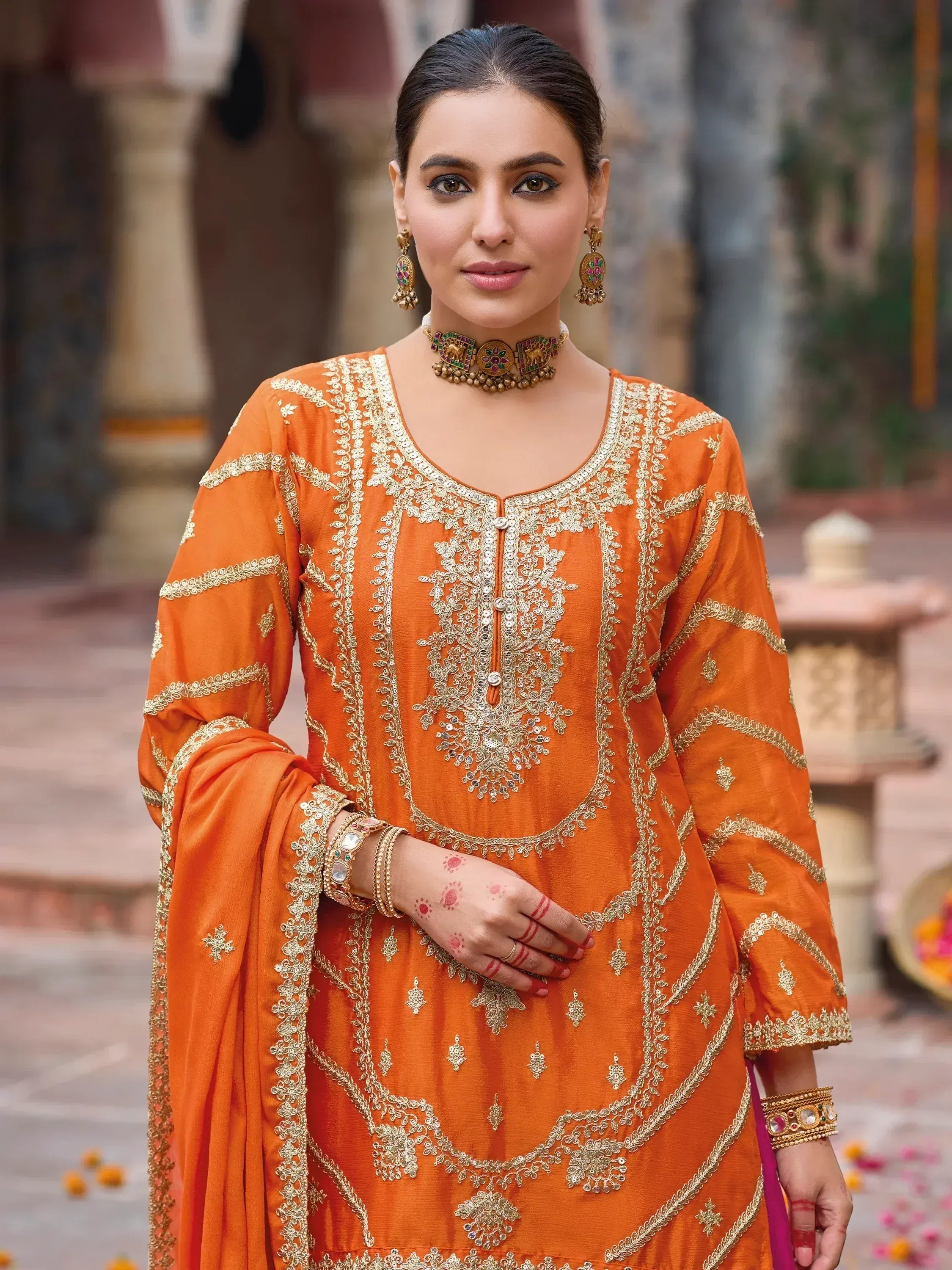 Orange embroidered salwar kameez with gold detailing, perfect for festive occasions and Indian ethnic wear.