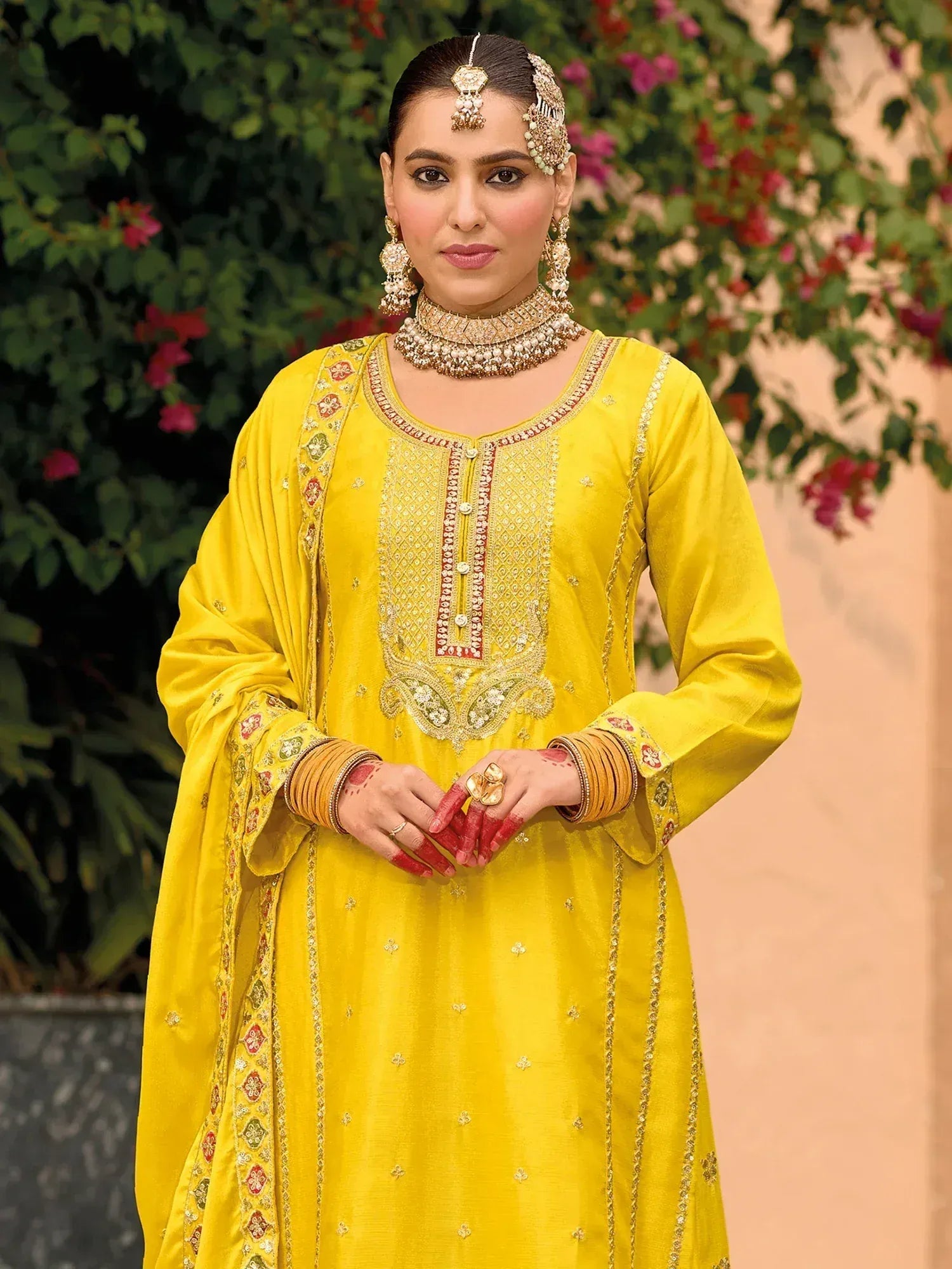 Yellow embroidered ethnic anarkali suit with traditional jewelry for Indian weddings