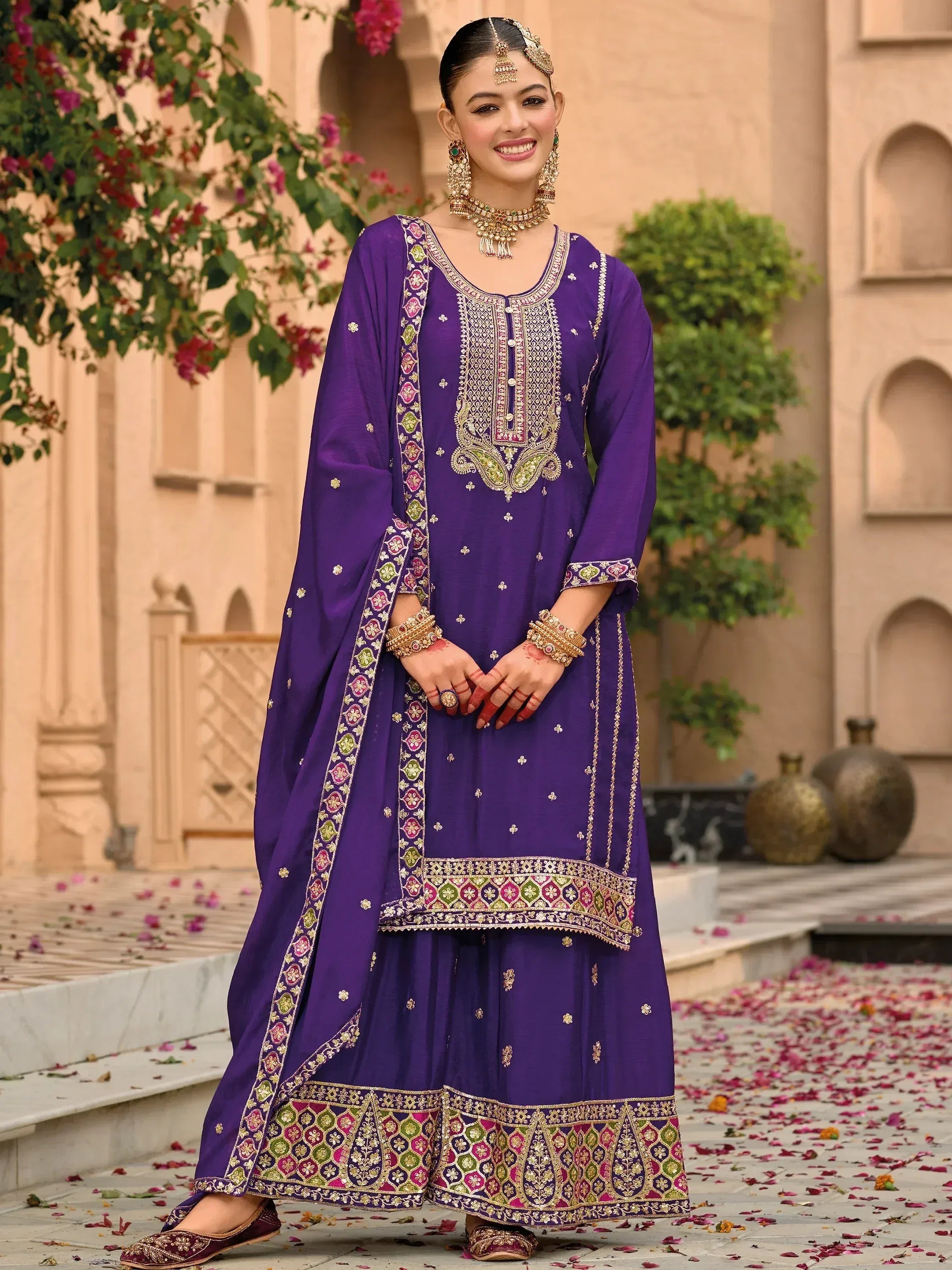 Purple embroidered salwar kameez with floral borders, perfect for Indian ethnic occasions