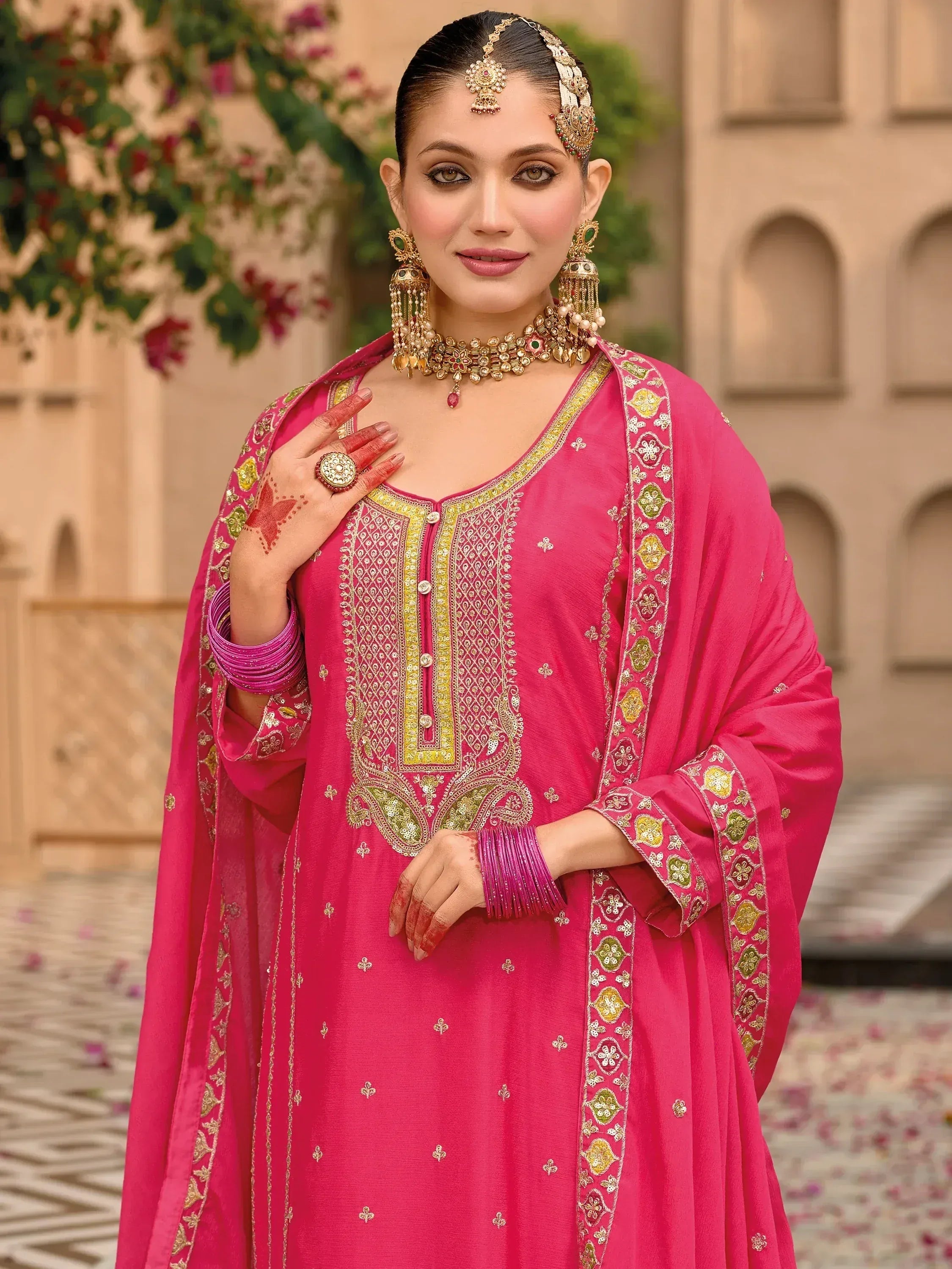 Pink embroidered salwar kameez with gold detailing, traditional Indian ethnic wear for women