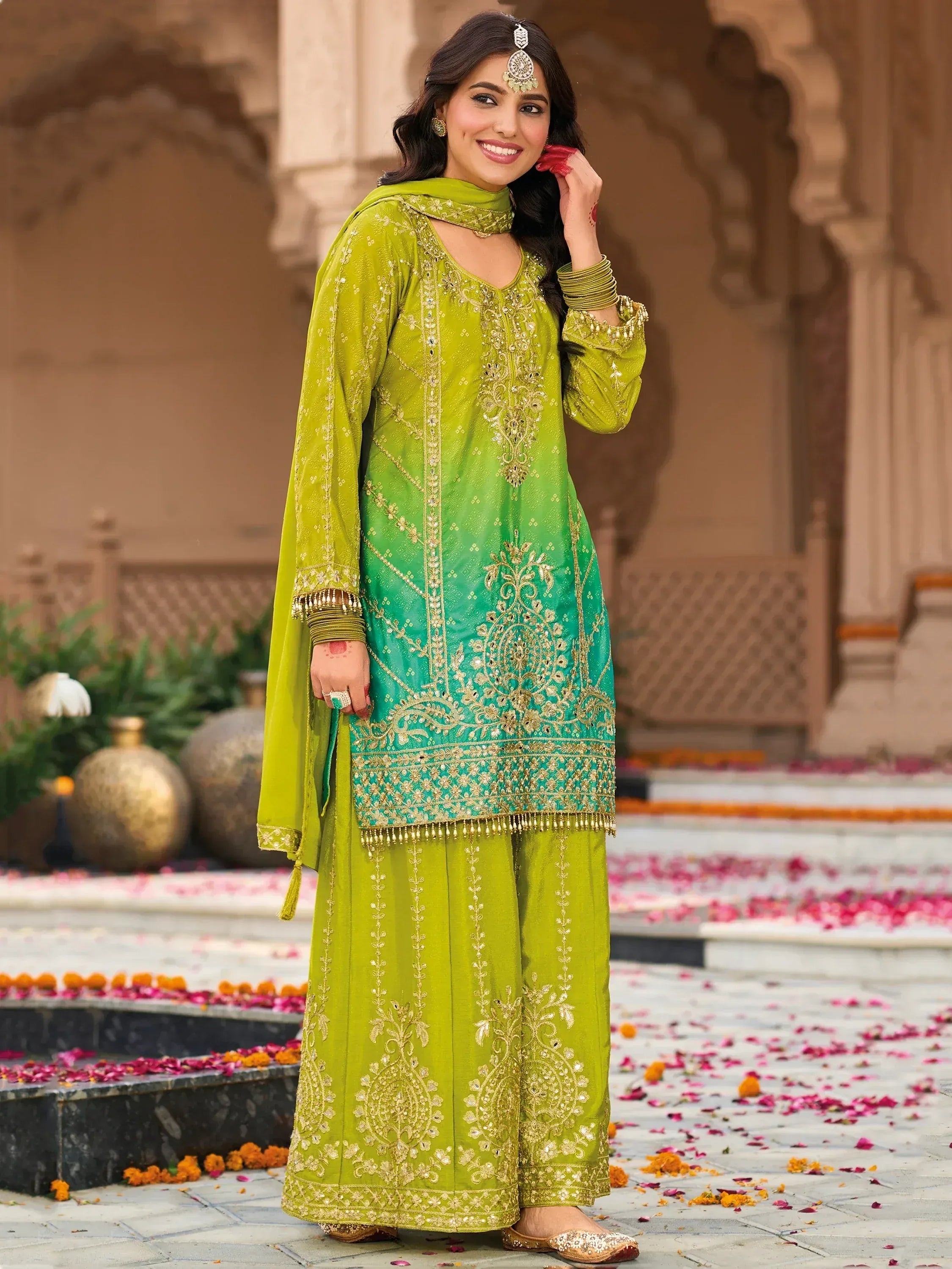 Green embroidered salwar kameez with gold detailing, perfect for festive occasions and traditional events.