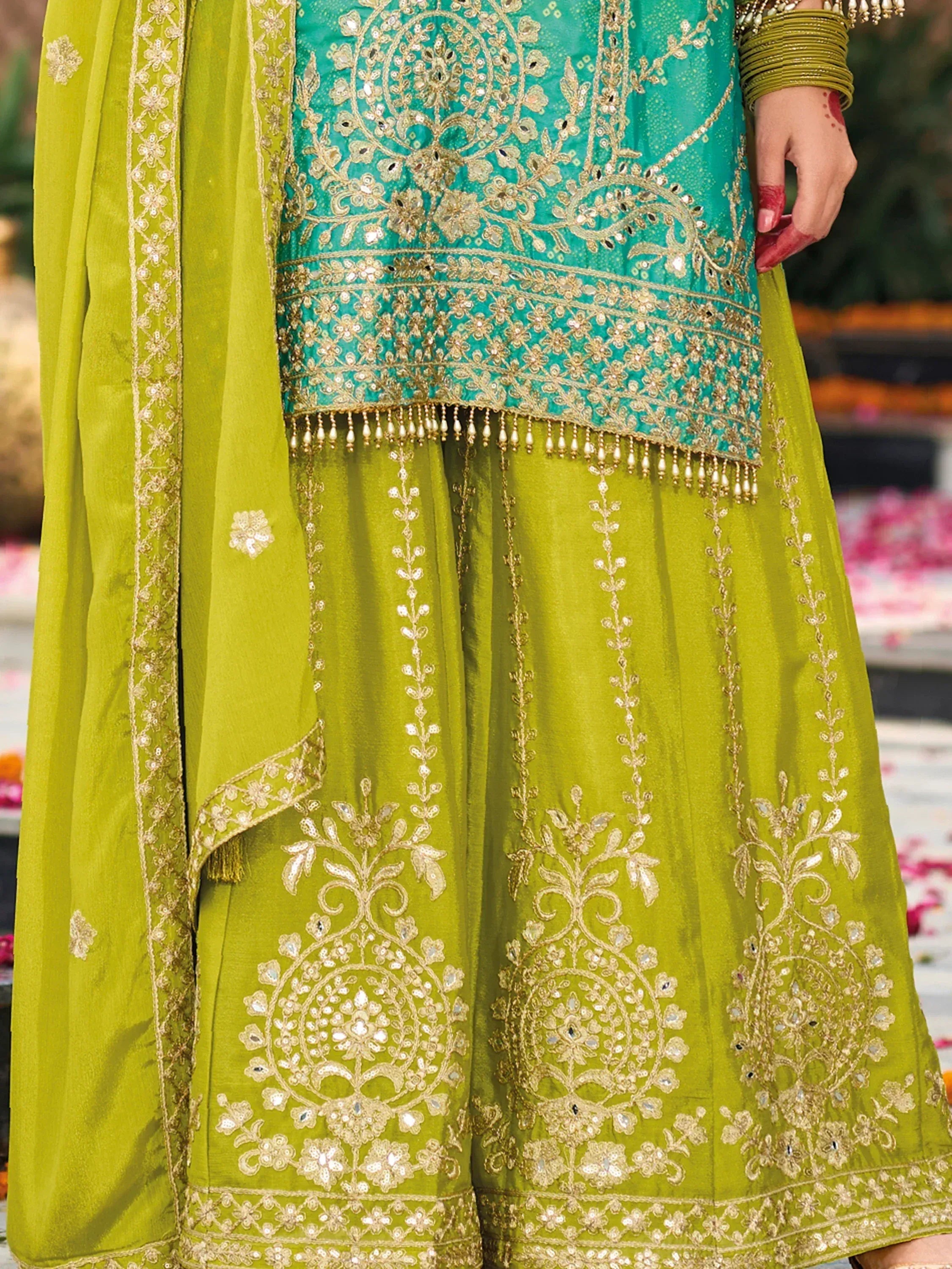 Green and teal embroidered lehenga choli with gold detailing and tassels, perfect for Indian ethnic wear.