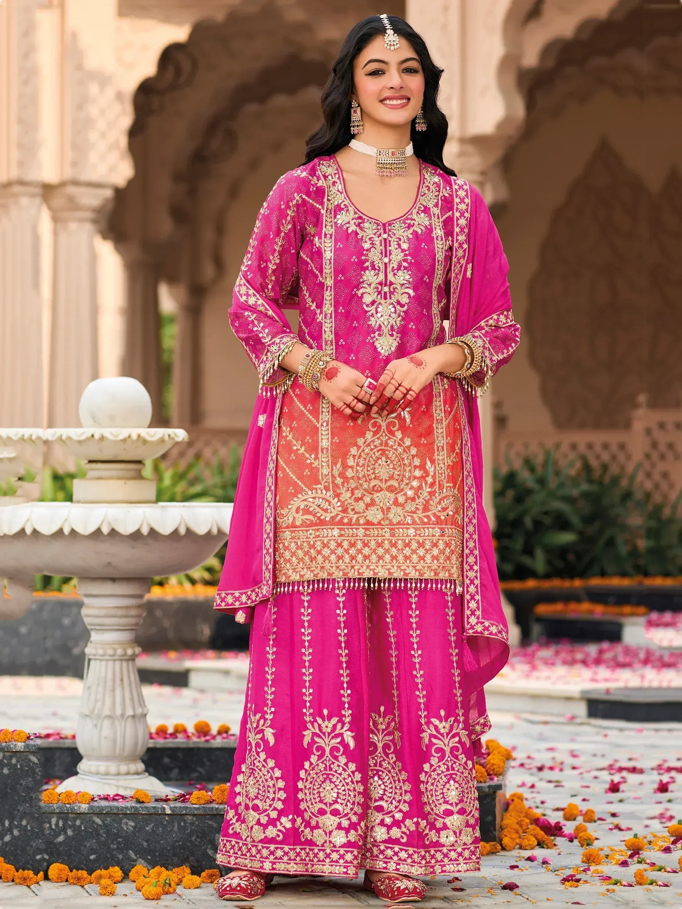 Pink embroidered Indian salwar kameez with gold work, perfect for festive occasions and weddings.