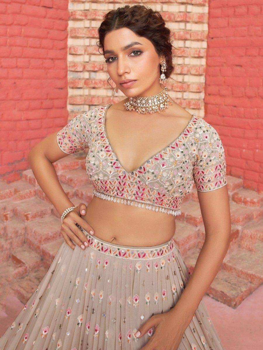 Floral embroidered lehenga choli with V-neck blouse, perfect for Indian weddings and festive occasions.