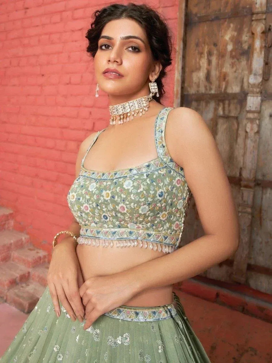 Green floral embroidered lehenga choli with mirror work, perfect for Indian ethnic wear occasions