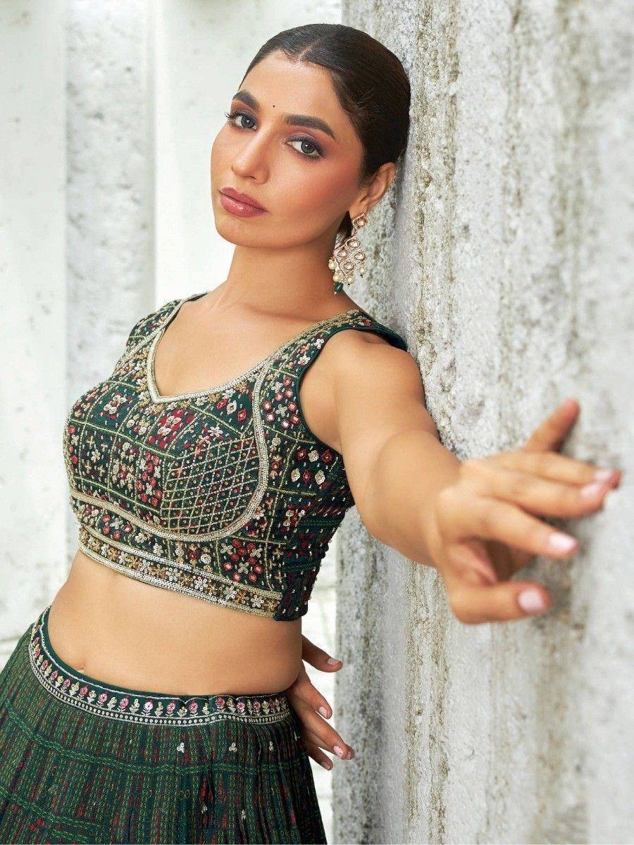 Elegant green embroidered lehenga choli with floral motifs, perfect for Indian ethnic wear occasions.