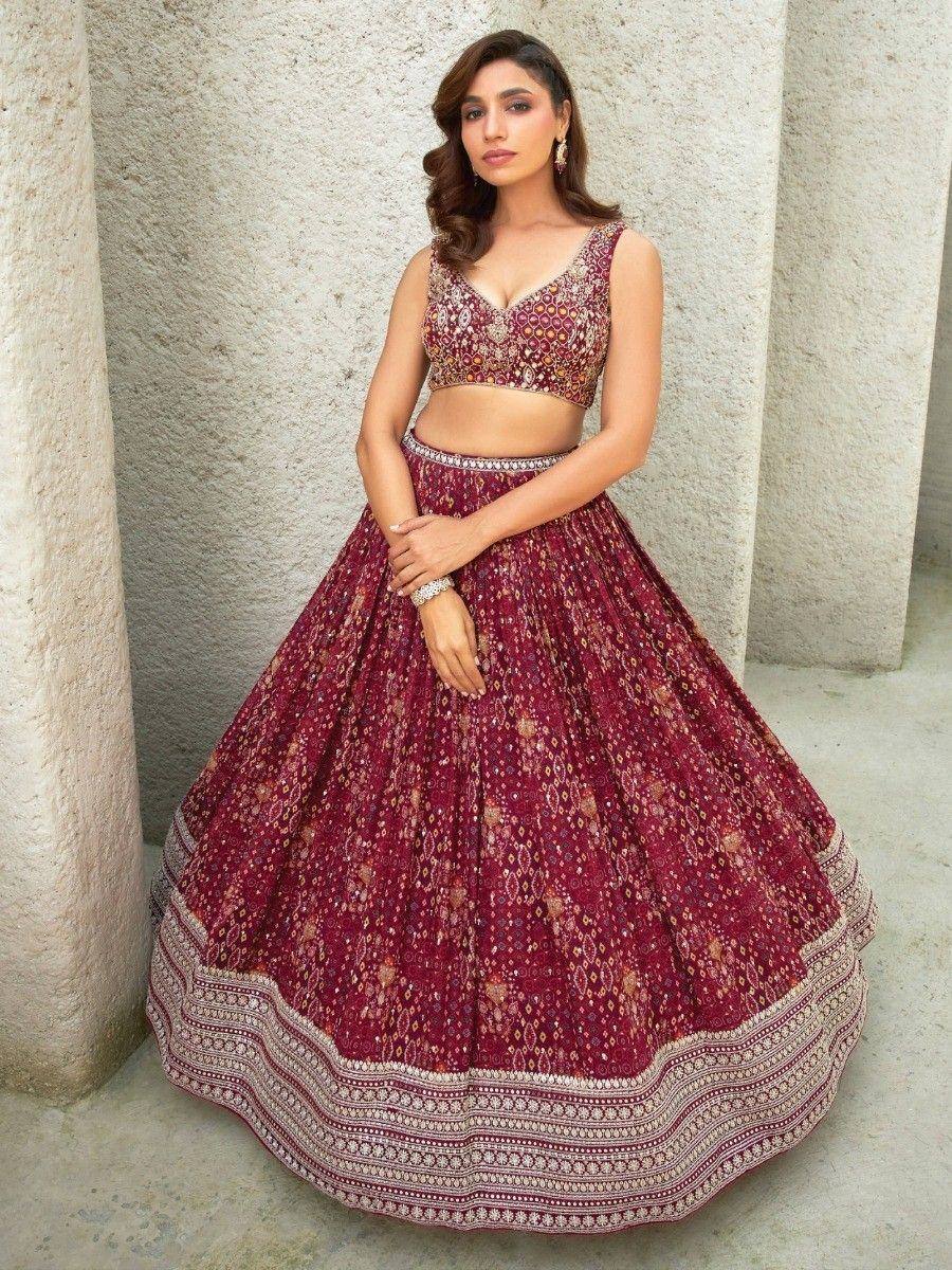 Maroon embroidered lehenga choli with floral motifs and detailed border, perfect for Indian ethnic occasions