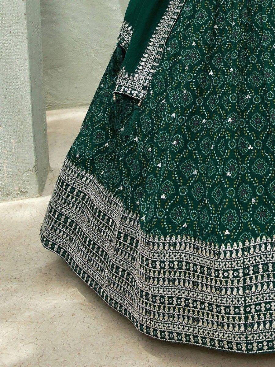 Emerald green lehenga with intricate white embroidery and mirror work, perfect for Indian ethnic wear.