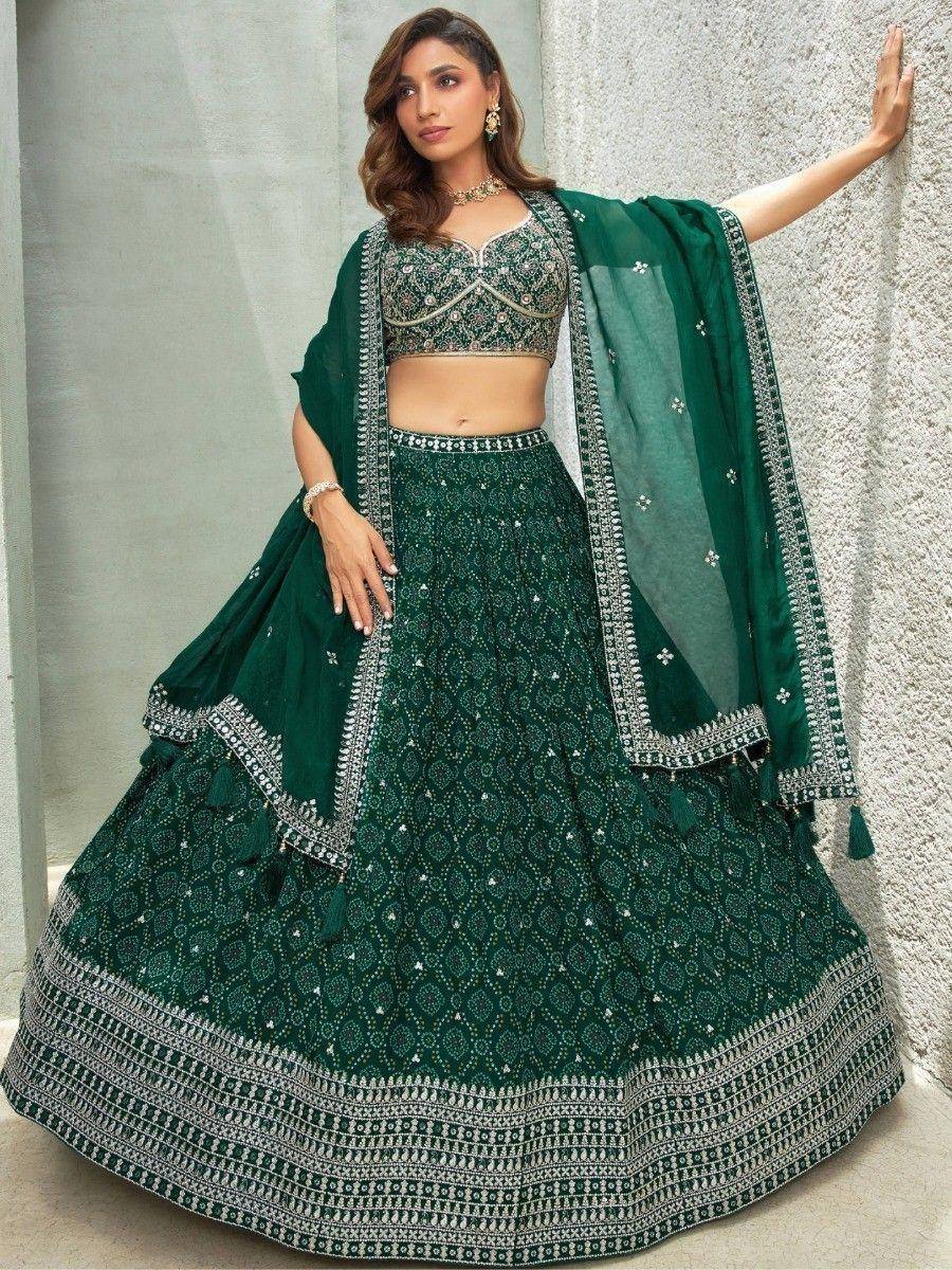 Emerald green designer lehenga choli with intricate silver embroidery and matching dupatta for Indian ethnic wear