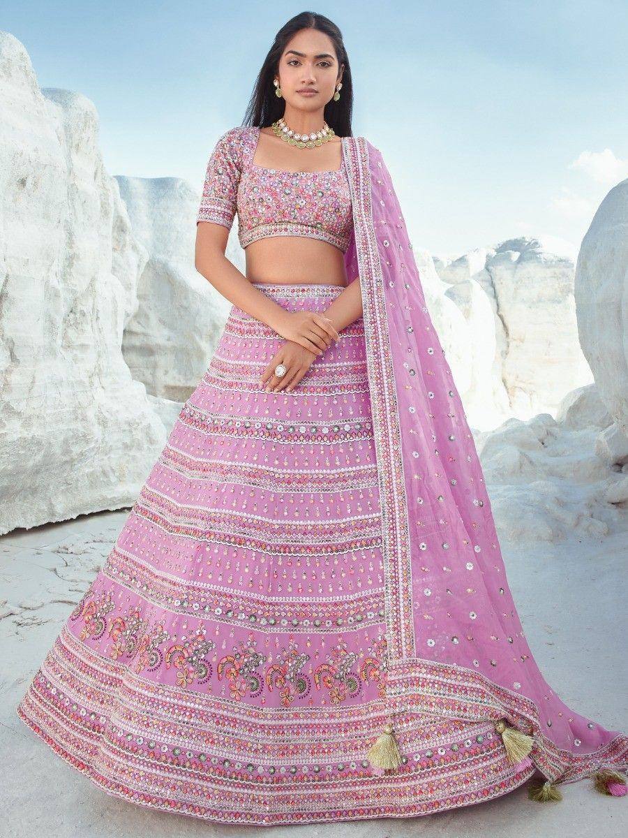 Pink embroidered lehenga choli with floral motifs and tassels, perfect for Indian ethnic occasions