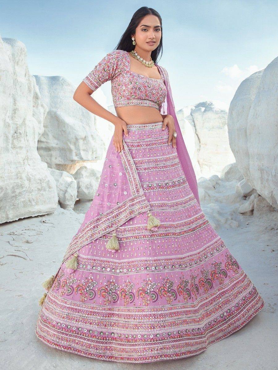 Pink embroidered lehenga choli with mirror work, perfect for Indian weddings and festive occasions