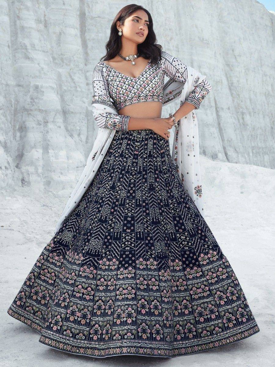 Elegant navy blue lehenga choli with floral embroidery and white dupatta, perfect for Indian ethnic occasions.