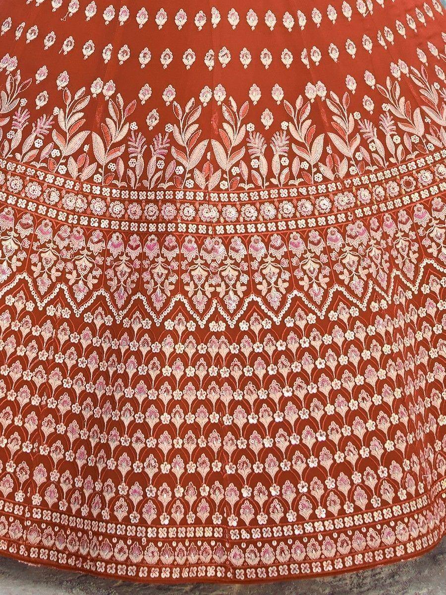 Rust-colored ethnic skirt with intricate floral and geometric embroidery, perfect for Indian wear.