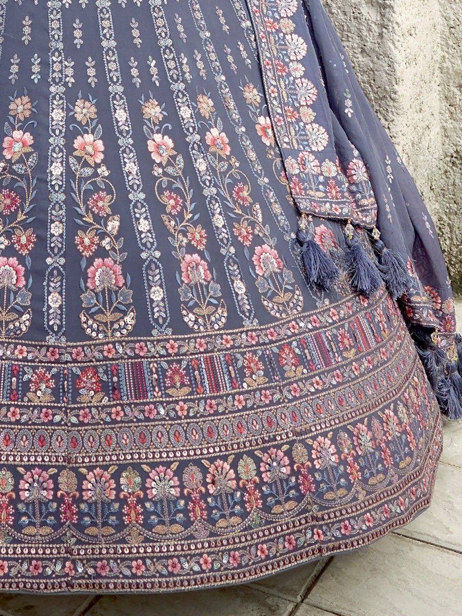 Dark blue lehenga with intricate floral embroidery and tassels, perfect for Indian ethnic wear occasions