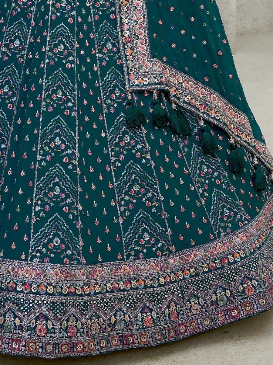 Emerald green lehenga with intricate floral embroidery and tassels, perfect for Indian ethnic wear