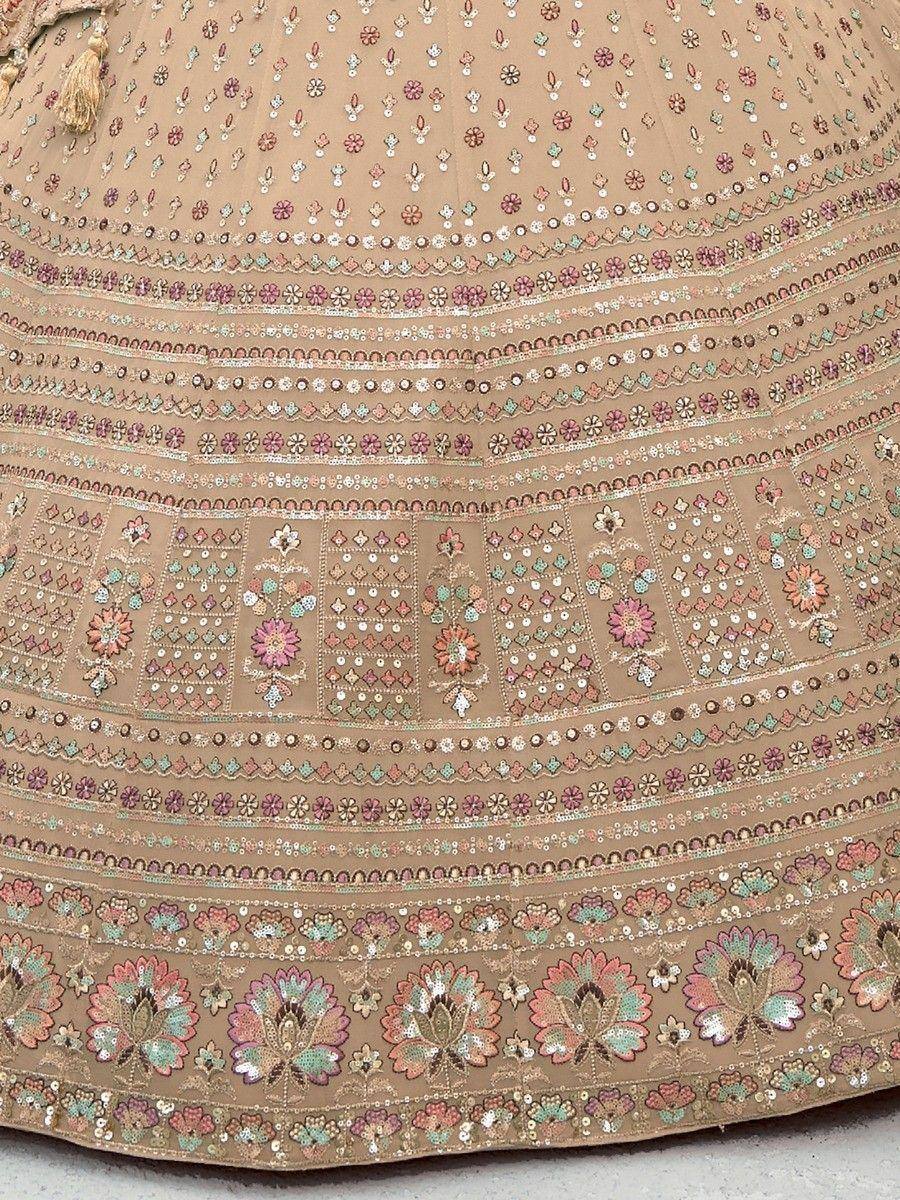 Beige lehenga with intricate floral embroidery and mirror work, perfect for Indian ethnic wear