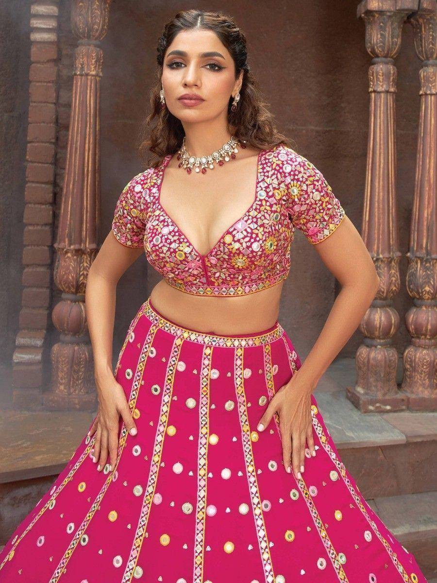 Pink embroidered lehenga choli with mirror work, perfect for Indian weddings and festive occasions